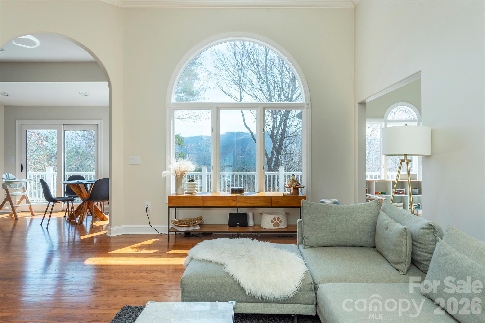 Perched within the peaceful, picturesque setting of Reems Creek Community & Golf Course - with no mandatory HOA dues and voluntary membership - this spacious brick home blends modern comfort, natural light and timeless elegance, just 7 minutes from charming downtown Weaverville, 20 minutes to Downtown Asheville and minutes to the Blue Ridge Parkways scenic vistas and abundant hiking. Soaring ceilings, expansive windows and distant mountain views fill the living room with warmth and character, while the fireplace invites a natural gathering place. Entertain in the formal dining room or step onto the full-length deck to take in quiet mornings and sweeping views of the serene Blue Ridge Mountains. The gracefully designed main level features three bedrooms, two bathrooms and a bright bonus room ideal for a refined home office, cozy reading retreat or creative studio. Downstairs, the airy lower level offers unusually tall ceilings, a spacious family room with a second fireplace, a fourth bedroom and third full bath - perfectly suited for guests, multigenerational living or relaxed evenings of entertaining. Bright and newly finished in 2024, the sunlit Gym space offers exceptional flexibility for work, wellness, or recreation - while the oversized utility room provides abundant storage and exciting future expansion potential. The generous lower patio creates yet another inviting place to unwind with your morning coffee or savor cool mountain evenings surrounded by peaceful scenery. Extensive recent upgrades include a new roof and gutters (2024), Energy Star high-efficiency gas furnace (2024), Energy Star tankless gas water heater (2024), new AC condenser and coil (2025), plus fresh paint, recessed lighting and updated fixtures throughout. Set within the quiet beauty of an established golf course community, this move-in-ready home offers an exceptional balance of comfort, sophistication and relaxed mountain living. Residents have the opportunity to join Reems Creek Golf Club, featuring an 18-hole golf course, newly updated pickleball courts, swimming pool, clubhouse, grill and bar along with a variety of social events and activities that further enhance the community lifestyle. For membership options visit: www.reemscreekgolf.com