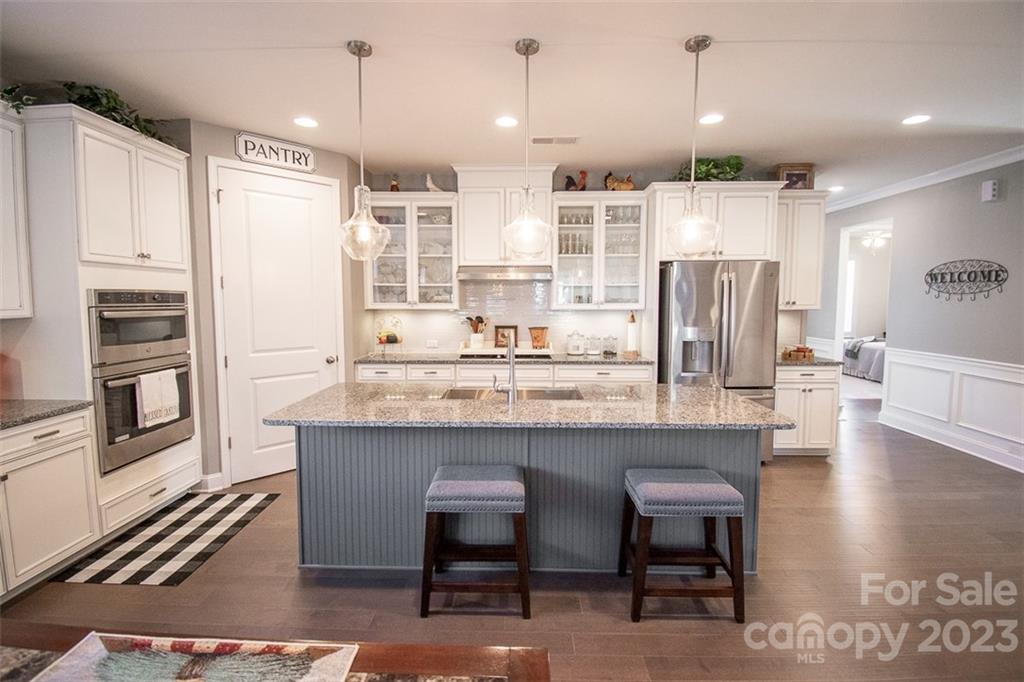 This is The One You’ve Been Searching For!  Beautiful 3 bedroom, 3 full bathrooms, 1.5 story home on a picturesque cul-de-sac lot in Indian Land’s popular Bent Creek Community.  High end builder finishes and seller add ons make this property one of a kind.  At 2,500 sq feet, it’s not too big and not too small, but just the right size to feel like home. Main level boasts gorgeous hardwoods, 9-foot ceilings, Chef’s kitchen, cozy fireplace, Primary suite and laundry, secondary bedroom with full bath, and a flex space ideal for an office, dining room, or reading room. 2nd level has a huge loft, bedroom and full bath. Inviting front porch and semi-private screened porch in back with fenced yard and storage shed. Community pool, fitness center, playground, dog park, sidewalks and trails. Close to Indian Land and Waxhaw shopping and dining and convenient to Ballantyne, Fort Mill, Lancaster, Rock Hill, Charlotte, major highways and the airport. Don’t delay, make this your home today!