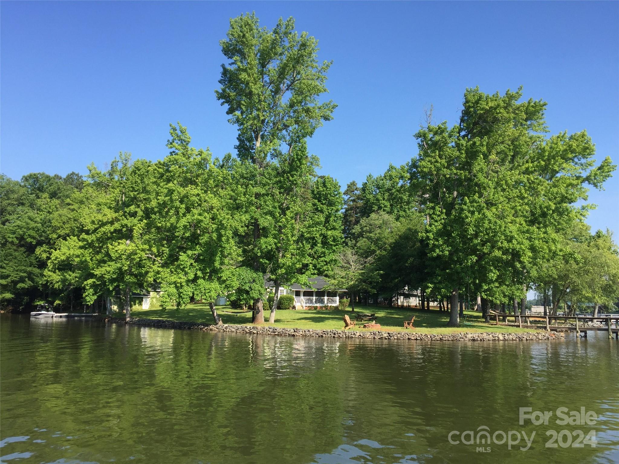 Extraordinary waterfront property with 500 feet of shoreline on the mouth of Crowders Creek.  Main house and guesthouse situated on level lot providing unlimited recreational access from two deep water docks.  2 bedrooms, 1 bath cottage complete with fireplace and screened front porch overlook large front lawn and sandy beach.  Boasts separate 1 bedroom, 1 bath guesthouse with boathouse.  Age of structures are unknown.  Located in highly sought after Clover school district.  This lakefront home is not only a perfect retreat with fantastic water views, but also provides access to nearby restaurants, shopping, convenient to Charlotte and airport.  Property is owned by listing agent.
