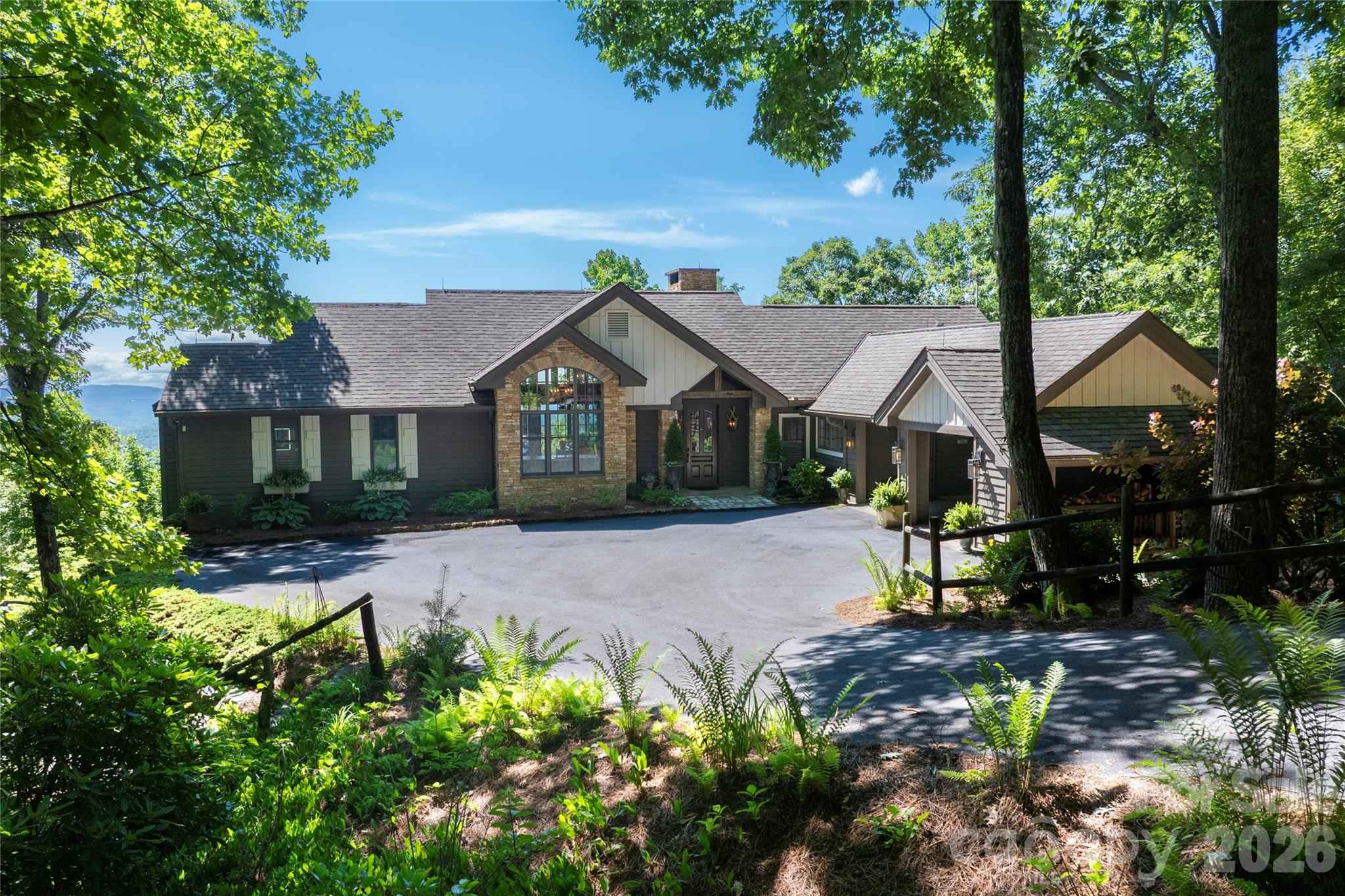 Set within the prestigious Meadow Ridge section of Lake Toxaway Estates, this beautifully updated mountain retreat offers exceptional privacy, timeless craftsmanship, and direct access to the natural beauty of Western North Carolina. Situated on 2.42 acres bordering a serene preserve of native wildflowers and rhododendrons, the home is surrounded by thousands of acres of protected forest while remaining just moments from the Meadow Ridge Pavilion and scenic trails into Panthertown Valley. Designed by renowned architect Al Platt, the 4,691-square-foot residence features four spacious bedroom suites, including two primary suites on the main level and two additional primary suites on the lower level, providing exceptional flexibility for family and guests. Native stone fireplaces anchor both living levels, while expansive decks invite year-round enjoyment of the peaceful mountain setting. An extensive remodel highlights a chef's kitchen with premium finishes, including a granite backsplash and custom range hood, thoughtfully designed for both everyday living and entertaining. The luxurious main-level primary suite features a spa-inspired bath with a steam shower, while custom window treatments and plantation shutters add warmth and elegance throughout the home. Additional updates include two tankless water heaters and a new 25kW whole-house generator for modern comfort and peace of mind. Offering the perfect balance of luxury, privacy, and outdoor adventure, this exceptional Meadow Ridge home is an ideal full-time residence or mountain getaway within one of Lake Toxaway Estates' most sought-after communities. Membership to LTCC is based on application and availability.