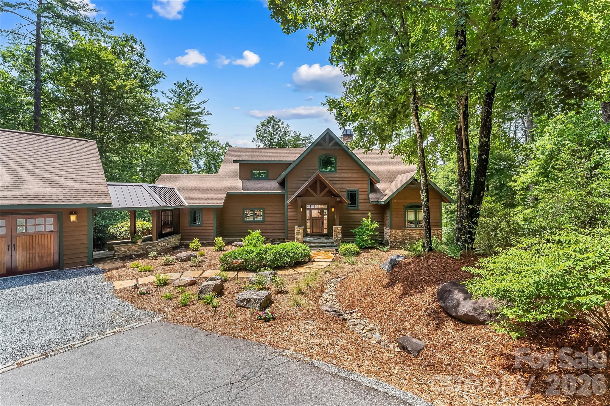 Exceptional Arts & Crafts lakefront retreat showcasing superior craftsmanship, timeless architectural details, and thoughtfully designed spaces for both everyday living and entertaining. Rich custom built-ins, beamed ceilings, and warm wood accents create an inviting atmosphere with exceptional water views throughout the house. Rare 1780  lot with gentle walk to the lake and the natural beach. The main level is anchored by a dramatic great room featuring a soaring floor-to-ceiling stone gas fireplace, exposed beams, and a wall of windows framing the lake views. The adjoining dining area flows seamlessly into the well-appointed kitchen complete with a large island, gas cooktop, double ovens, abundant cabinetry, and a nearby pantry with an additional refrigerator and spacious laundry room with sink and cabinetry.  You'll love the lake views from the primary suite featuring private deck access, dual walk-in closet, ensuite bath with a soaking tub and beautifully tiled shower. One of the home's most distinctive gathering spaces is the expansive screened porch, highlighted by unique poplar bark accent walls, laurel twig railings and cozy gas log fireplace—perfect for enjoying every season. An uncovered deck extends from the great room, providing additional outdoor living space overlooking the water. Upstairs, you'll find an additional bedroom, full bath, private office with a Murphy bed for overflow guests, and walk-in attic storage. The lower level is designed for recreation with a spacious family room centered around a second stone gas fireplace, game room and wet bar. One private bedroom and one bunk room share the hall bath. Half bath with easy outdoor access leads to a private outdoor shower. A covered breezeway connects the oversized detached two-car garage to the home. Outside, multiple outdoor living areas include a lower-level patio, fire pit, and an easy walk to the lake through the mountain laurel. Enjoy a covered deck, sandy beach area, and a private, single slip floating dock. Take a short ride to Camp Lake James and enjoy the lake's largest amenity area with pool, hot tub, fitness center, pickleball courts, social hall with canteen and expedition center with bar.