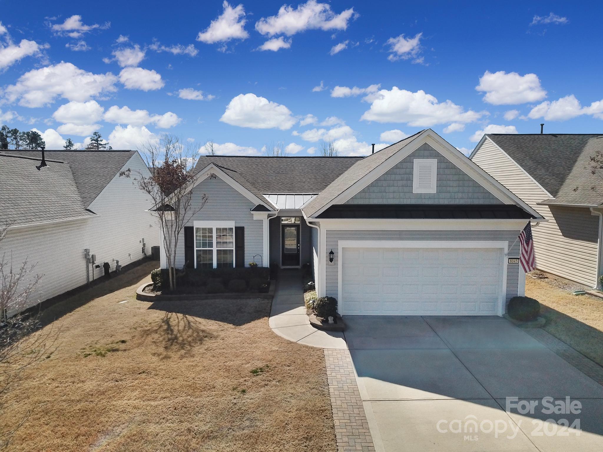 Beautiful Copper Ridge home w/ upgrades including a new fridge (2024) & dishwasher (2023), gas HW water (2020), HVAC air scrubber (2019), programmable thermostat, extended paver patio & pergola, & a decorative glass front door w/ a transom window! Pre-finished wood flooring flows through the main living areas, kitchen, & primary bedroom! Kitchen boasts granite counters, SS appliances, angled serving bar, tile backsplash, under cab lighting, & a trash can pull-out. The open great room has a gas-log fireplace w/ a blower. It flows into the dining area & sunroom, which has lots of windows & leads out to the extended paver patio w/ a pergola, overlooking the private view. French doors open to the office w/ adjustable fixed shelving & a desk! At the rear of the home is the primary suite w/ an ensuite bath featuring a frameless glass shower w/ grab bars, dual sink marble-top vanity, & a custom closet! The 2-car extended garage has attached shelving & a widened driveway. Don't miss this home!
