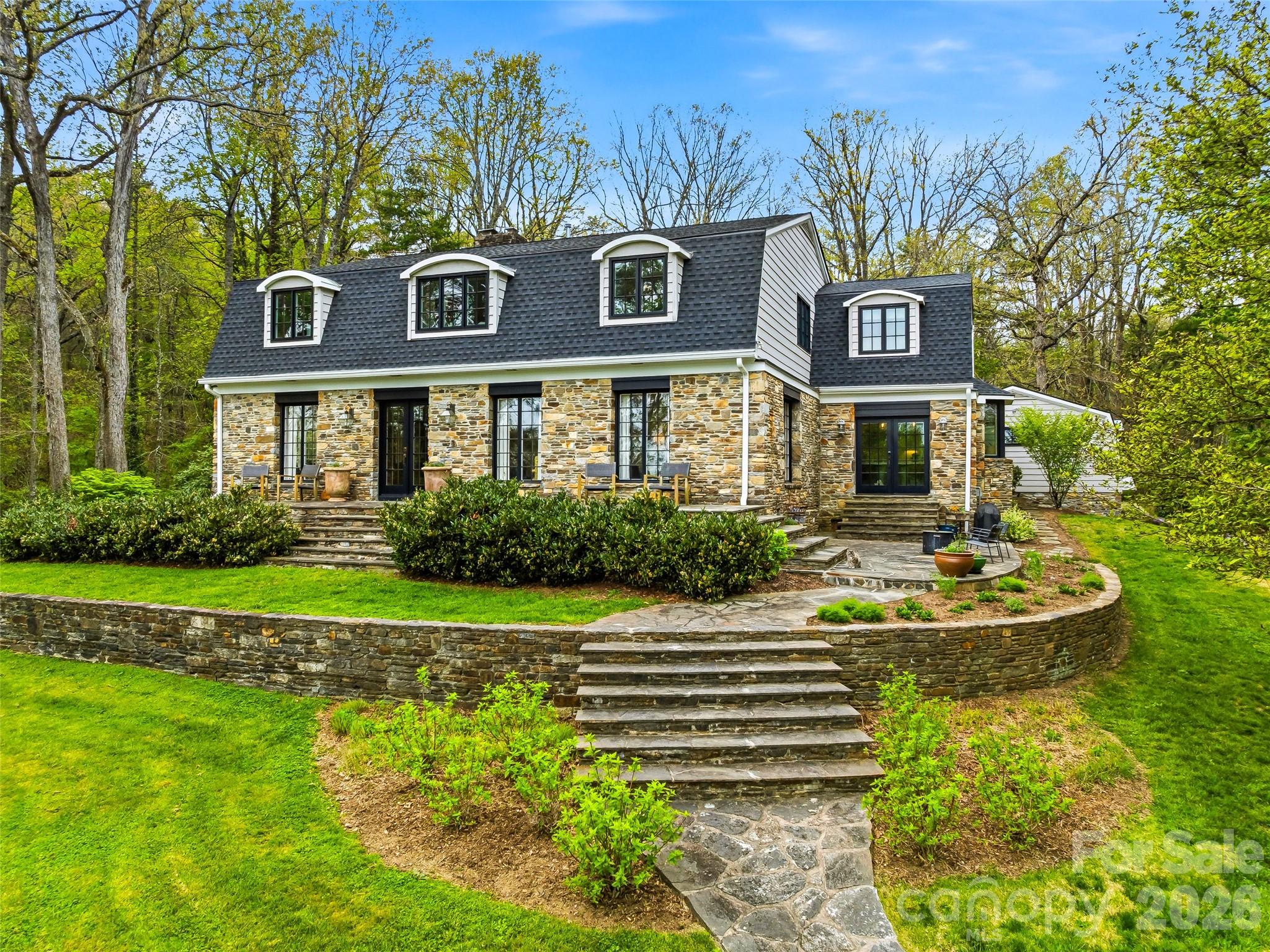 A rare legacy estate offering an extraordinary blend of historic character and refined modern living, this 5,800 sq ft residence is set on 10.88 private acres just minutes from downtown Hendersonville. Thoughtfully updated with all major systems renovated since 2014, the home preserves its architectural integrity while delivering effortless comfort. Five bedrooms, 4 full and 2 half baths—including a private guest wing—provide space for both intimate living and elegant entertaining. Long-range mountain views, established walking trails, a resort-style pool, and multiple outbuildings create a setting of exceptional privacy and versatility. A truly rare opportunity to own a timeless estate in one of Western North Carolina’s most desirable locations.