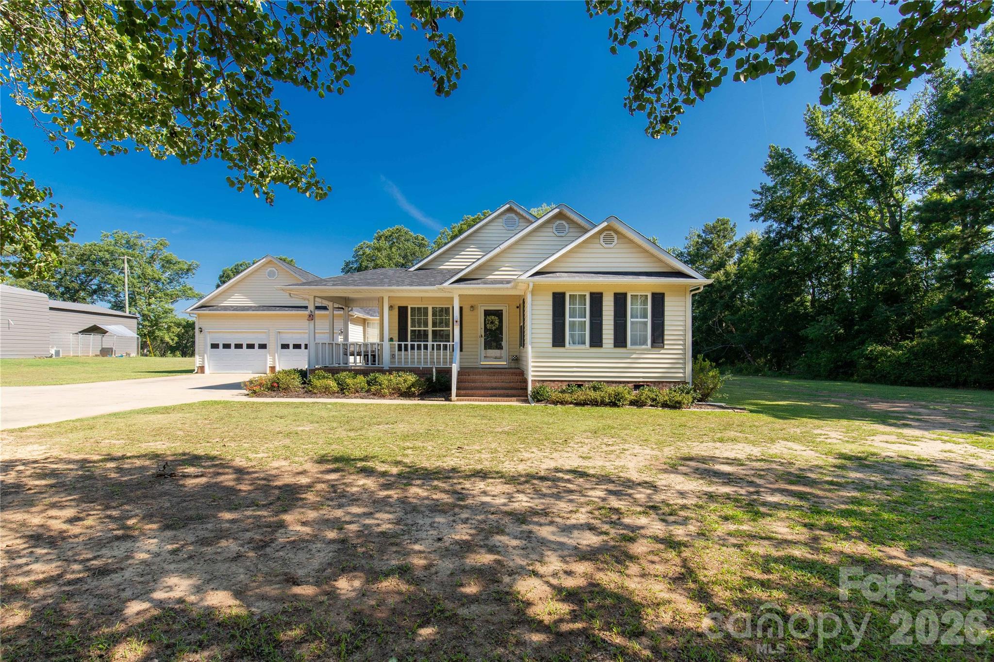 Looking for space, flexibility, and room to spread out? This unique property sits on over an acre in the highly desirable Buford School District and offers a floor plan that can adapt to your needs.

Originally built as a 3-bedroom, 2-bath home, the seller has converted a portion of the attached garage into two additional rooms. Prefer garage space instead? The seller is willing to convert the area back, giving buyers the flexibility to choose the layout that works best for them.

Inside, you'll find a spacious living room, tall ceilings throughout much of the home, and a large primary suite designed for comfort. The eat-in kitchen features a center island with a cooktop, wall oven, pantry, and plenty of space for gathering with family and friends.

Enjoy peaceful outdoor living from the covered wraparound porch or relax on the rear porch overlooking the expansive yard. A breezeway connects the home to the garage area and offers endless possibilities as a home office, sunroom, hobby space, or flex room. Need extra storage or a place for projects? The detached wired shop provides plenty of room for tools, equipment, outdoor toys, or a workshop.

With flexible living spaces, abundant storage, and over an acre to enjoy, this property offers the perfect blend of country living and everyday convenience.