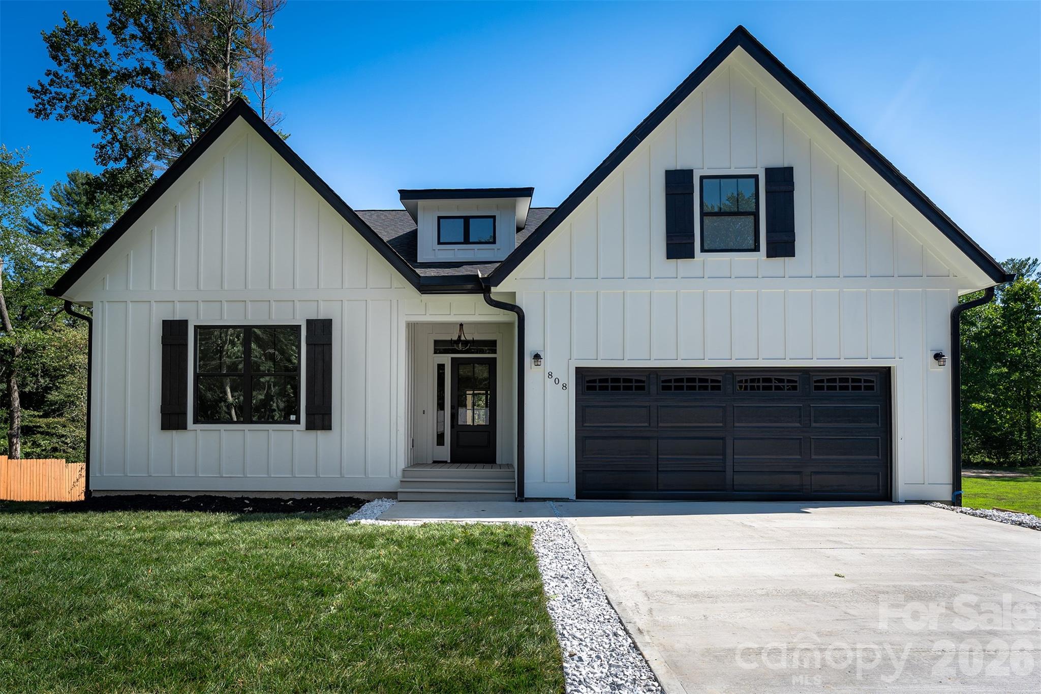 Beautiful newer construction Modern Farmhouse with a Craftsman touch, located less than 3 minutes from Downtown Hendersonville! This thoughtfully designed home welcomes you with an open-concept layout and a stunning floor-to-ceiling gas fireplace as the focal point of the living space. Enjoy seamless indoor-outdoor living with a fully covered deck overlooking a private backyard, perfect for relaxing or entertaining.

Situated on a private lot, this home offers both charm and functionality with upgraded finishes throughout. Features include hardwood flooring, vaulted ceilings, solid wood doors and cabinetry, and a modern trim package. The kitchen is appointed with quartz and granite countertops, a gas range, and quality fixtures.  

The home is equipped with energy-efficient and high-performance systems, including gas HVAC, a tankless gas water heater, and insulated interior walls. Both full bathrooms feature heated tile floors and floor-to-ceiling tiled showers for added comfort and luxury. 

Additional highlights include a fully insulated "tall" crawlspace with sump pump and generator backup, 6” gutter system with drainage, termite protection system, and a transferable roof warranty. A two-car garage and extended concrete driveway provide ample parking, with no HOA restrictions.   Front yard features new sod, and backyard has been freshly seeded. 

Conveniently located minutes from shopping, dining, and everyday essentials, and approximately 25 minutes to Asheville Regional Airport.

Home is currently tenant-occupied and the lease is in place until January 31, 2027.  Showings are by appointment only and please do not disturb the tenants. Photos are from past post-construction time and may include virtual staging. Fridge, Washer, Dryer and shower glass door now installed and not shown in photos. Tax Bill is for land only will be adjusted for construction of home for the 2026 tax year.