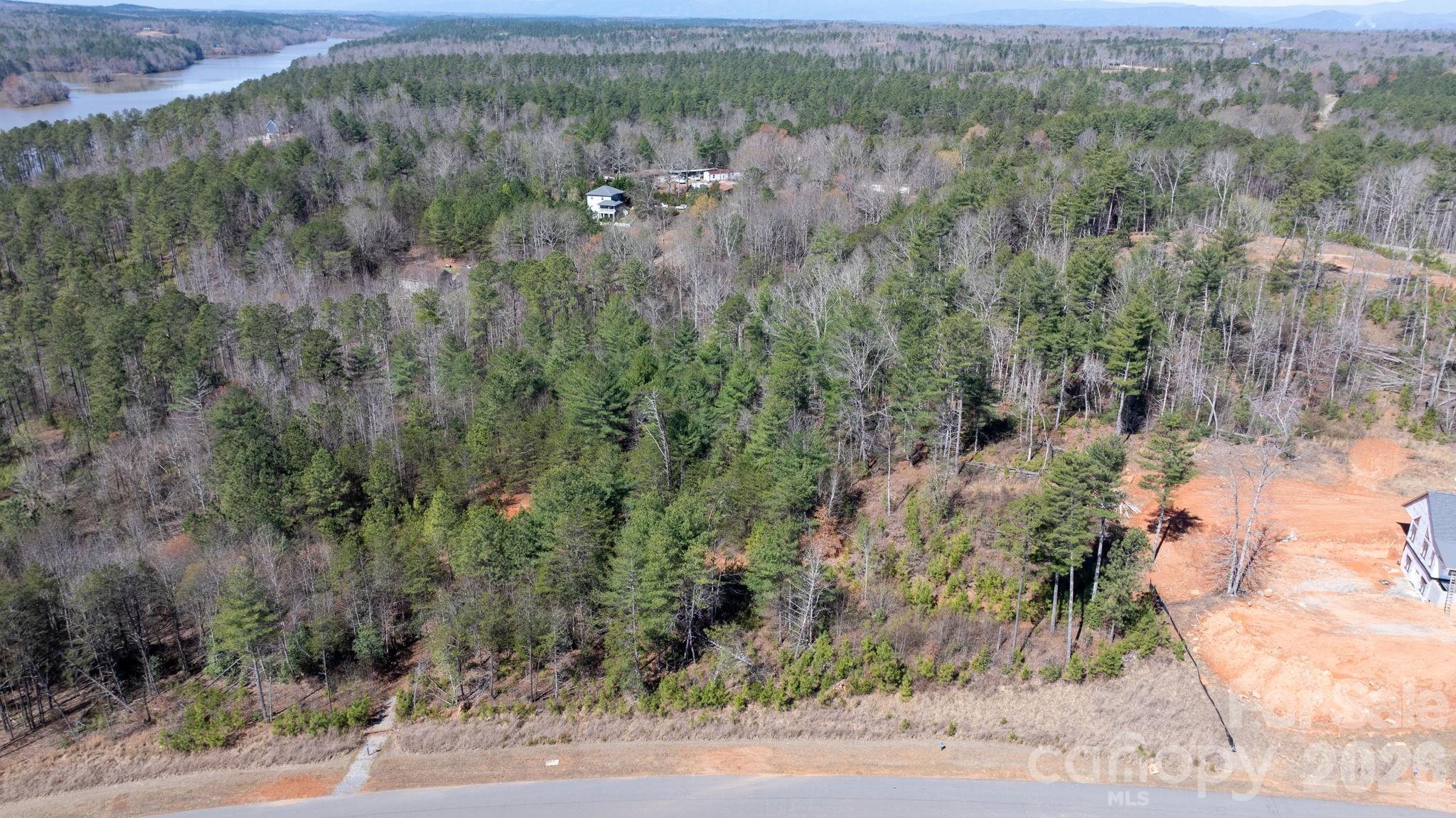 Discover the perfect setting for your custom home in the gated community of The Waterfront Club in Granite Falls! This 1.688-acre lot offers privacy while still enjoying wonderful neighborhood amenities. Residents have access to Lake Rhodhiss with multiple lake access points, a sandy beach for swimming, a floating dock for fishing, and a clubhouse with pool overlooking the lake. Conveniently located near shopping, dining, and medical facilities, with easy access to Asheville, Charlotte, and nearby ski resorts.