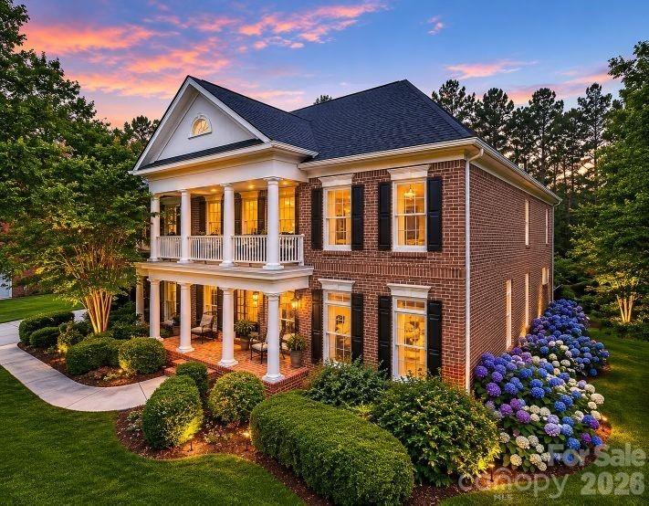 This beautiful all-brick estate home is gracefully positioned on a premium homesite within the highly sought-after Brookhaven community. Tucked away on a quiet cul-de-sac, this distinguished John Wieland residence showcases timeless elegance, exceptional craftsmanship, and thoughtfully curated living spaces designed for both comfortable everyday living and sophisticated entertaining.
A grand two-story foyer with a sweeping staircase sets the tone for the home’s interior, leading into a light-filled family room with fireplace and beautiful architectural detailing, all framed by sweeping views of the lush, park-like surroundings. At the heart of the home is the chef’s kitchen, exquisitely appointed with professional-grade appliances, including a Wolf four-burner gas range with integrated BBQ/charbroiler and ventilation hood, a built-in KitchenAid refrigerator, a custom island, a butler’s pantry, a casual dining area, and seamless flow for effortless entertaining.
The luxurious primary suite offers a true private sanctuary, featuring a coffered ceiling, gracious sitting area, spa-inspired bath, dual walk-in closets, and an adjoining flex space ideal for a luxe home office, yoga studio, or private reading lounge. A private veranda just off the suite creates the perfect setting for peaceful mornings with coffee overlooking the tranquil grounds. Three additional generously sized bedrooms complete the upper level, including one with an ensuite bath and two connected by a Jack-and-Jill bath. The expansive finished third floor, complete with a full bath, offers exceptional versatility and is ideal for a media room, game nights, guest accommodations, or a private retreat. There is ample storage, too!  Step outside to your own outdoor sanctuary, thoughtfully designed for both relaxation and entertaining. Enjoy multiple patio spaces, a covered veranda for al fresco dining, a charming pergola, and beautifully landscaped grounds enhanced by mature trees and vibrant flowering plantings.  A private trail provides access to Brookhaven’s premier resort-style amenities, including a clubhouse, resort-style pool with lazy river, tennis courts, fitness center, and scenic walking trails. Perfectly situated just minutes from downtown Matthews, The Shops at Waverly, Rea Farms, and Blakeney—and zoned for the highly acclaimed Weddington school district—this exceptional estate offers a lifestyle of distinction, refinement, and enduring appeal. Updates include a new roof (2021), 2nd floor HVAC replaced in 2025, see disclosure statement for additional details.