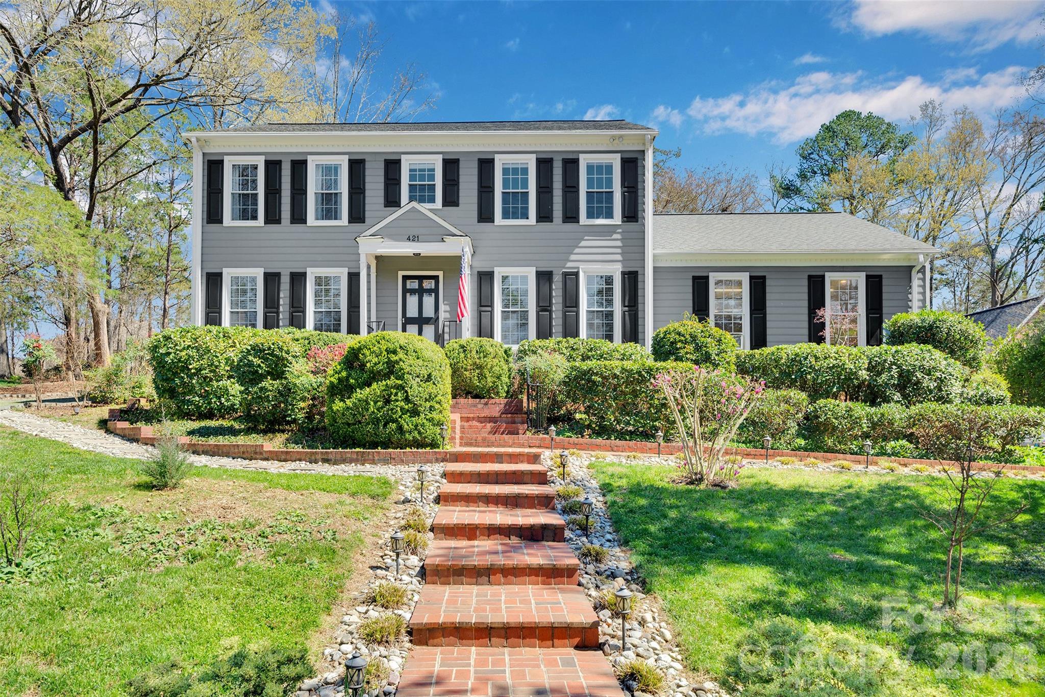Welcome Home to your private oasis in the heart of Charlotte! This home has all the features you are looking for and more including an impressive garage set up for the car enthusiast in your life. 

Renovated kitchen with double oven and gas range. HUGE living room perfect for entertaining and a very spacious dining room. There are gorgeous hardwood floors throughout the main level and partially upstairs. Everything in this home has been meticioulsly maintained. The cozy den with gas fireplace, built-in bookcases and window seat opens to the kitchen, foyer and screened in porch. The generous screened in porch and deck are prefect for enjoying the stunning backyard. 

Upstairs you will find an oversized primary suite with his/hers vanity bathroom with personal linen closet and walk-in closet. Off the closet is 250+ sf of walk-in attic with skylight that can be transformed into a home gym, office, additional closet space, or keep it as storage! So many possibilities. The 3 secondary bedrooms are all generous in size with 2 having large walk-in closets and the other having 2 separate closets. The hall bath has been updated with stylish tile and has dual vanities and a linen closet. The upstairs landing has pull down attic access and yet another large linen closet- storage for days! 

The attached garage is two stories tall with ceiling fan and wall AC unit. There is a large utility sink, exhaust vent and plenty of garage storage. There is full height, walk in double door access to additional crawlspace storage. Also in the garage you will see a car lift. The lift is not attached and does not remain with the sale but is available for purchase outside of closing. Reach out for details on the lift. There is also an oversized detached double garage and is so big that it currently houses 3 cars with 2 small cars parked in tandem. The sellers also have architectural plans to add a second story/apartment above the existing space. BOTH garages are plumbed for hot/cold water and compressed air. In addition, the attached garaged includes a natural gas connection. 

The outdoors are stunning and a gardener's dream. The natural and garden areas have been well maintained and when in full foliage you are in completely tucked in to your oasis. There is a fire pit for relaxing outside with a stockpile of wood that will last for years to come. The wrap around driveway works perfectly when entertaining but also allows you to tuck your trailers, campers, etc around the back side of the house. 

The home also comes with a backup generator that can supply the bedrooms, kitchen and water heater with electricity. Both refrigerators remain- kitchen and garage. Also remaining are the attached TVs in the kitchen and front guest room remain (both can be removed upon request), the washer and dryer, kitchen bar stools, all windows treatments, fireplace screen, the outside fountain and jasmine orb fixture by screened in porch, party lights outside, fire pit and wood, both garage wall vacuums, hose reels and air compressors. 

This home is stunning inside and out. You won't be disappointed. Every detail has been thoughtfully maintained. See website link for additional photos: https://listings.visionrealestatemedia.com/421-Sardis-Ln-Charlotte-NC-28270-USA?mls=4363122