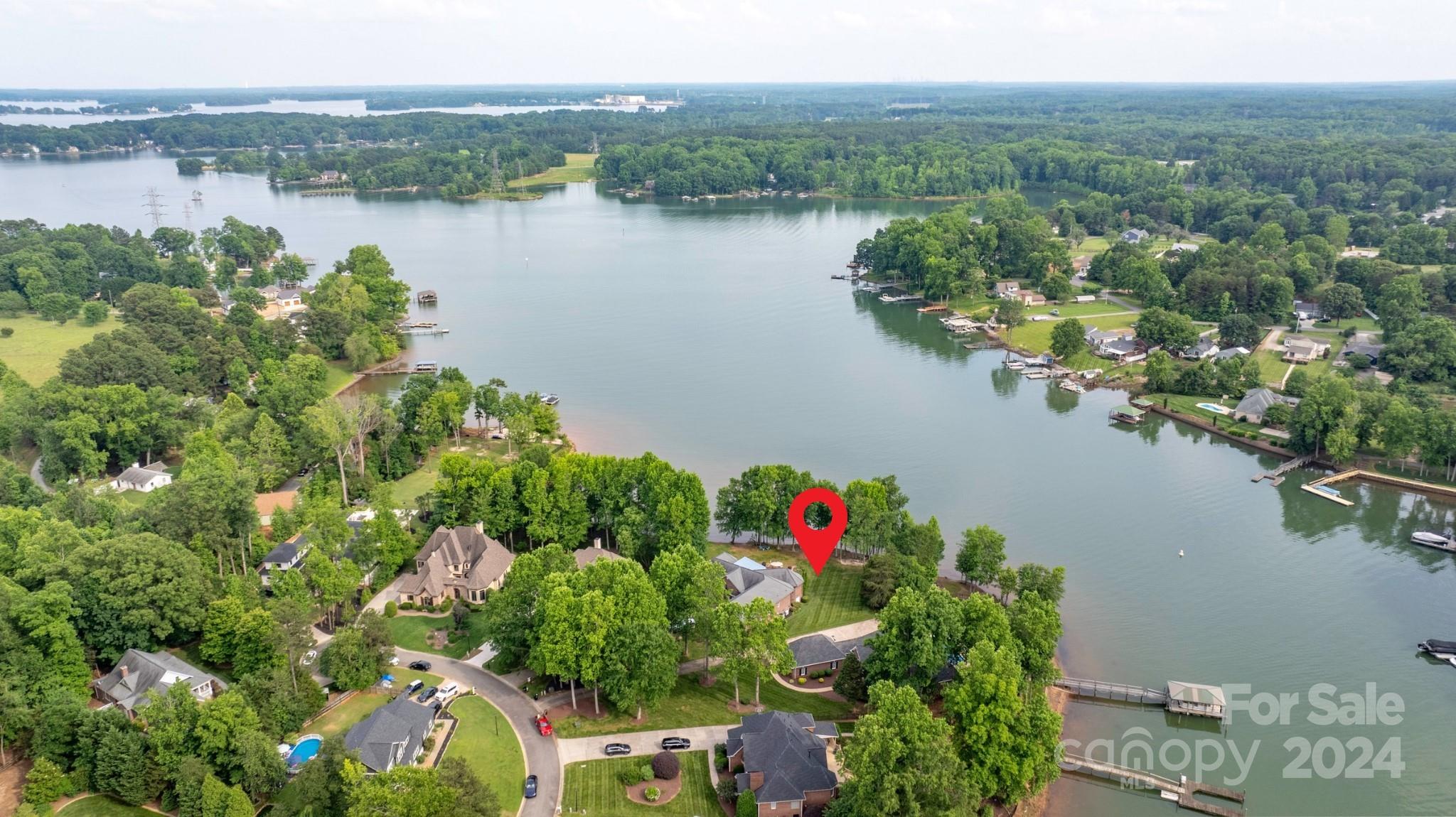 PRIVATE Lakeside Retreat w/Breathtaking PANORAMIC WATER VIEWS from almost every room! Pull your boat up to your 168' of shoreline right up to your outdoor oasis offering a covered living/dining space, paver patio fpl area, custom built waterfall/pond, & take your paddleboard/Kayaks right into the lake & float around w/ friends. This CUSTOM ALL BRICK RANCH HOME boasts quality in every space! Open Split Floorplan w/10-14' ceilings, Hardwoods, Custom oversized windows for STUNNING WATER VIEWS, Hurd custom doors,Solid interior doors, arched doorways, & 2x6 Construction framing! WViews from your Custom Kitchen w/ Granite countertops, Copper colored faucet, high end appliances, Eat-in Breakfast area, & oversized island are all perfect for entertaining & open to the Stately Gathering Room w/WViews, beautiful Stone fpl, & Wine bar. Gorgeous Primary Suite features WViews, fpl, tall ceilings, His/Her closets, and custom ensuite bath. Don't miss electric stairs in Garage to upper storage area.