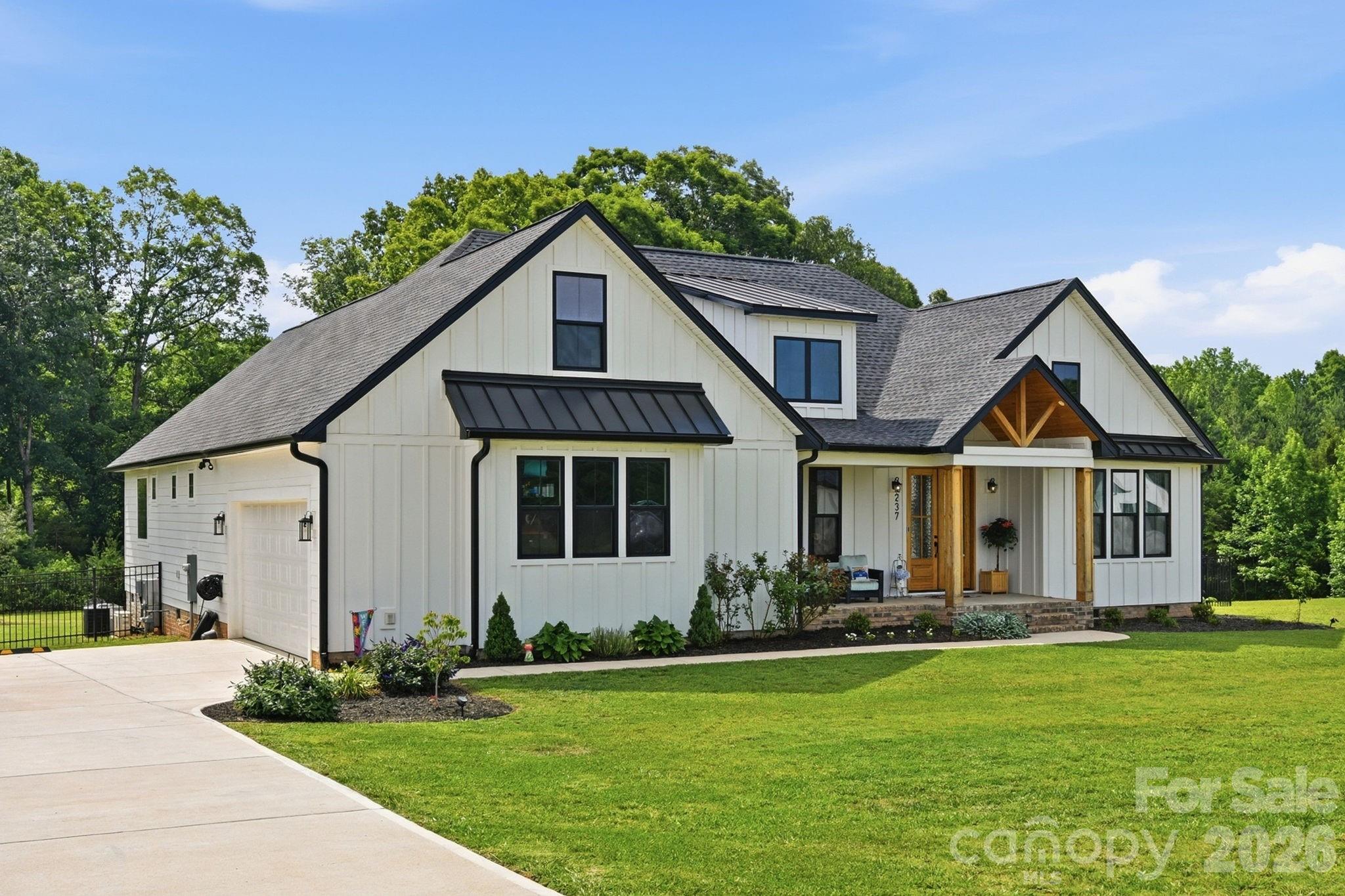 Better than new construction in desirable Edmunds Farm! Completed in 2024, this beautifully upgraded home offers the advantages of a newer home with thoughtful improvements already in place. Tucked away in a peaceful setting with larger homesites, yet just minutes from downtown Clover, this location offers the perfect balance of privacy and convenience. The open floor plan creates an inviting flow between the kitchen, living, and dining areas, while keeping the bedrooms privately positioned throughout. The kitchen is designed for both everyday living and entertaining with quartz countertops, large island with breakfast bar seating, Cafe appliances including induction range and dishwasher, decorative subway tile backsplash with accent tile detail behind the range, custom range hood, and an oversized walk-in pantry. The living room features a vaulted ceiling and shiplap fireplace, while the dining room showcases a coffered ceiling and wainscoting for timeless architectural detail. The spacious primary suite offers a spa-like retreat with dual vanities, freestanding soaking tub, custom tiled shower with dual shower heads and rain head, and two walk-in closets with built-ins, including one conveniently connected to the large laundry room. There is a spacious bonus room upstairs, a flex space with so many potential uses. Since purchase, the sellers have added all-new appliances, reverse osmosis tap, whole-home water filtration system, backyard fencing, enhanced landscaping, timed landscape lighting, and a complete security package with Ring alarm, cameras, doorbell, window sensors, and motion detectors. Outdoor living is easy with covered front and rear porches featuring cedar ceilings overlooking the fenced backyard. The home’s septic placement allows for future pool potential. A rare opportunity to enjoy a nearly new home with upgrades already completed!