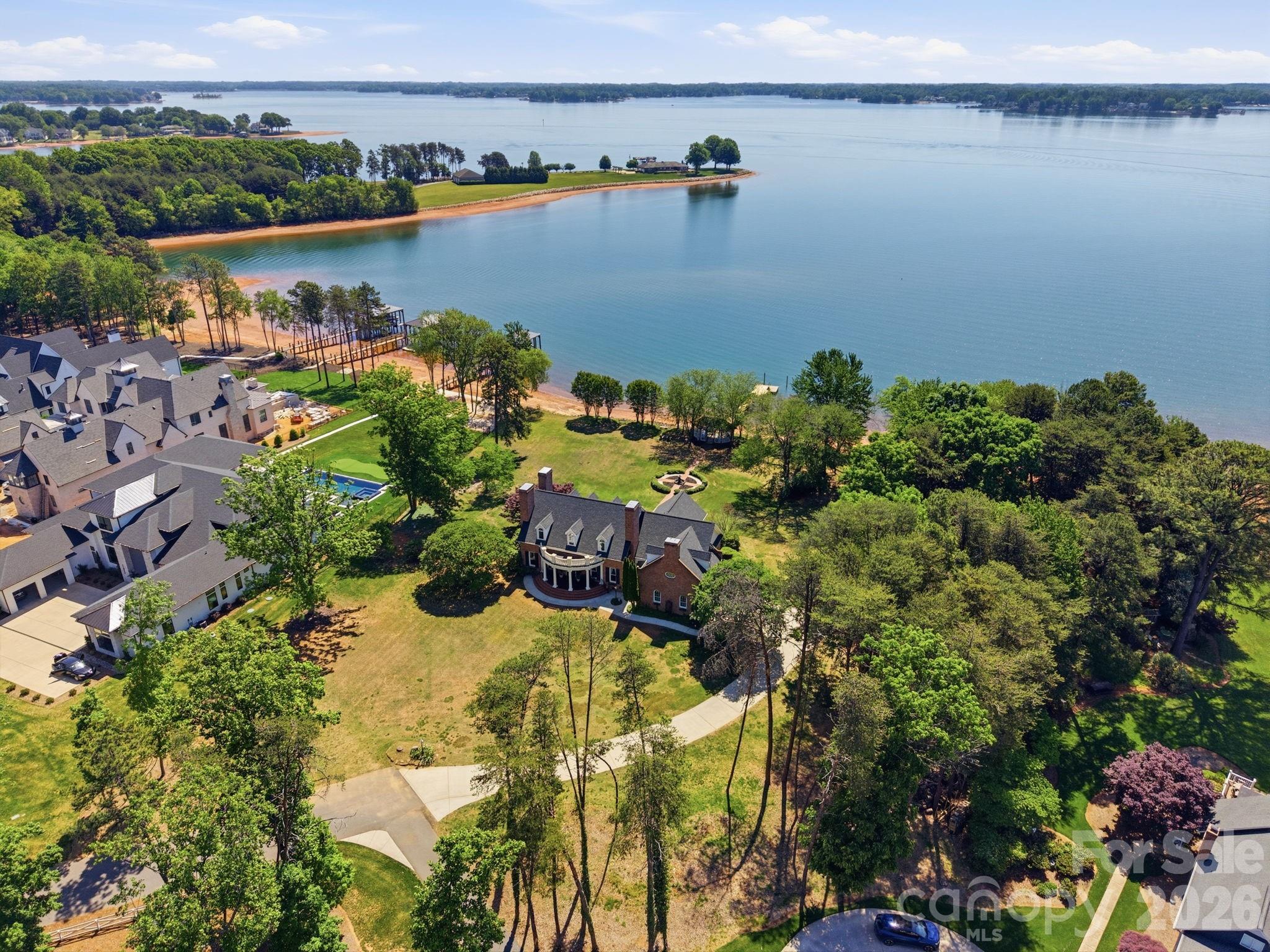 Don’t miss this rare opportunity to own a stunning piece of Lake Norman history. Cherished by the same family since before the lake’s creation, this full-brick Southern Living home sits on 1.44 acres with over 400 feet of pristine shoreline and some of the most expansive views on Lake Norman. Located in the prestigious Saylor’s Watch community—without the HOA dues or restrictions—this exceptional property offers a large, level lot complete with a lakeside gazebo and fire pit. Perfect for entertaining, it has even hosted numerous unforgettable waterfront weddings.  Rich in Southern charm, the home welcomes you with a classic front porch and opens to a spacious terrace overlooking the water. Inside, you’ll find unique artistic touches and distinctive details throughout, including a hand-painted dining room mural by the artist/owner, antique light fixtures, French doors, custom built-ins, and a generously sized kitchen designed for family gatherings. The main level features a serene lakeside primary suite with a luxurious bath and direct terrace access, along with a light-filled living room showcasing a wall of windows and a cozy fireplace. A private office or den with its own fireplace offers the perfect work-from-home retreat. In total, the home boasts three fireplaces, including one in the formal dining room. 
Upstairs, you’ll find three additional bedrooms, a spacious bonus room, and an enormous unfinished area offering endless possibilities for expansion. With unmatched waterfrontage, room to grow, and timeless character, this is truly a one-of-a-kind offering. Schedule your private tour today.