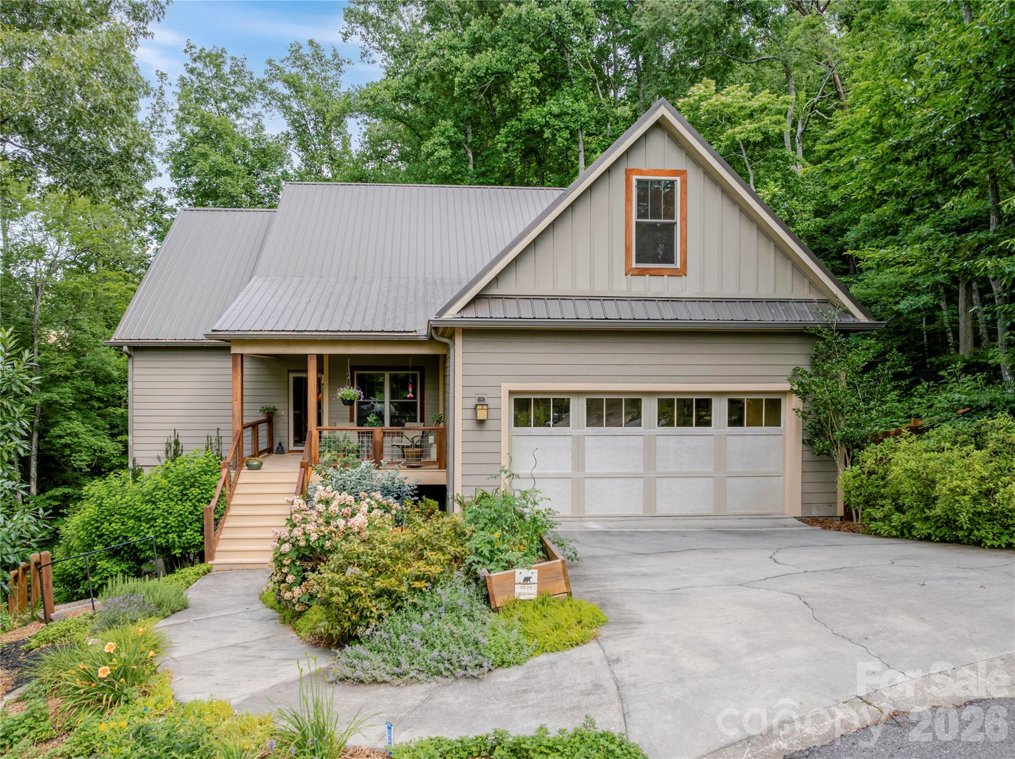 At the top of the hill, on the edge of the woods, you have discovered a rare opportunity in Swannanoa’s Bee Tree Forest community. On the market for the first time, 45 Sunset Drive is a modern mountain cottage that combines comfort, convenience, and privacy in a setting you will treasure. An inviting covered porch welcomes you, and overlooks a beautifully landscaped hillside of native plants. Inside, the home is centered around open living and dining spaces with a well-designed kitchen and a lovely three-season screened porch for taking in the leafy summer scene and autumn mountain vistas. French doors lead to a convenient home office at the front of the house. To one side, the main-level primary suite is perfectly scaled—comfortable, not cavernous—with views from the well-placed windows, a glass and tile shower, dual sinks, and a roomy walk-in closet. On the other side of the home, second and third bedrooms share a well-appointed full bathroom—a private sanctuary for guests or additional household members, or useful as a home studio and family room combination. Tucked above the garage, the fourth bedroom is a cozy refuge with slanted ceilings and eastern views overlooking the cut-de-sac. Hardwood and tile floors, a main-level laundry room, and a spacious two-car garage complement the efficient layout. The fenced back yard, in a terraced design to prevent erosion, offers a sanctuary for gardening and relaxation while the adjoining mature woods enhance the privacy of the nearly half-acre lot. All these comforts are located in an appealing established neighborhood minutes from shopping, dining, services, and a variety of schools. Asheville and Black Mountain are nearly equidistant destinations, offering additional amenities within just a few miles, and the Blue Ridge Parkway is only 10 minutes away. This is the one! Come and see.