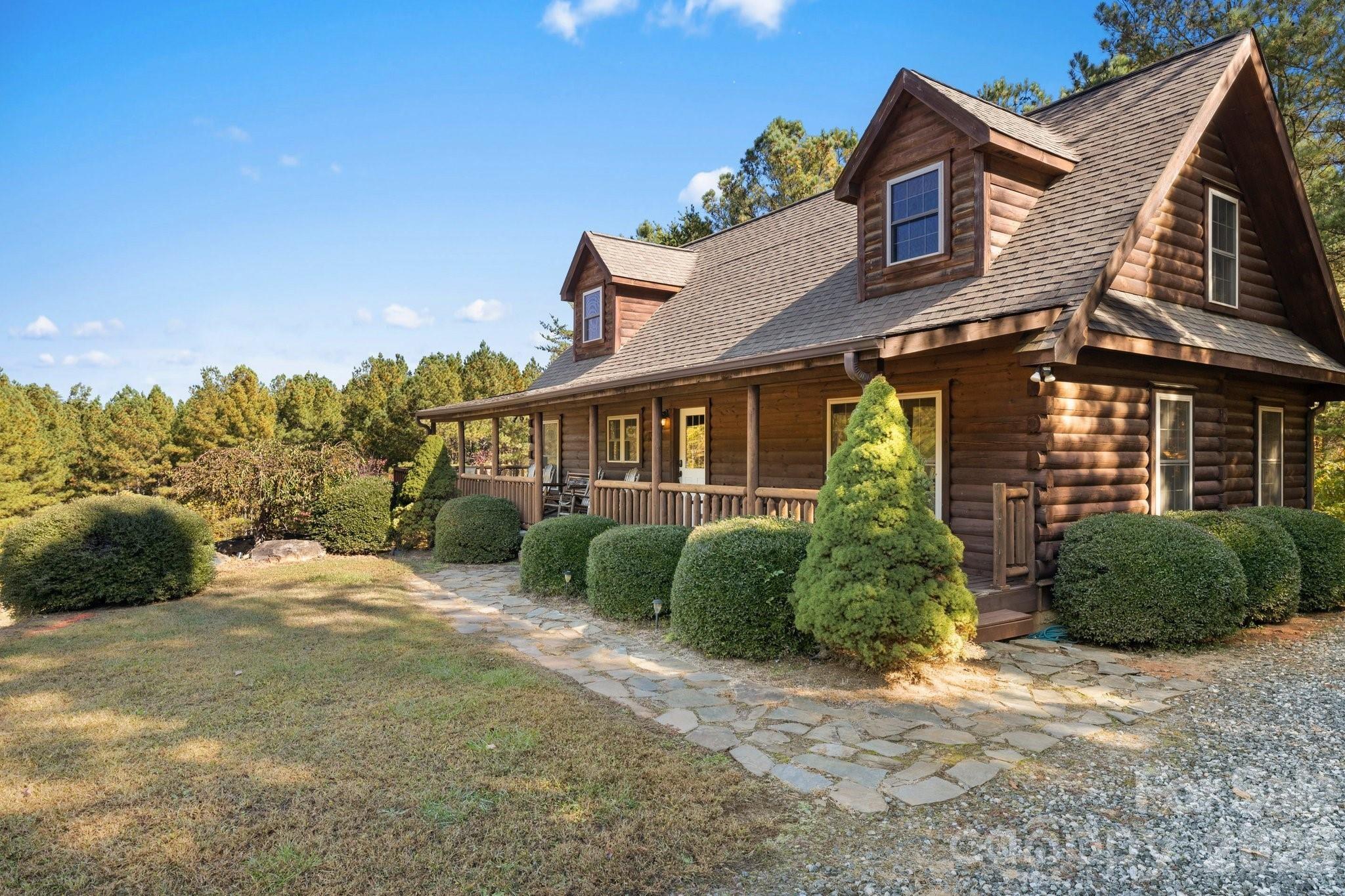 Turn-key log home vacation rental is ready to make your living in the mountains a dream come true! This 4-bedroom, 3.5 bath cabin will take your breath away! Home is 7 miles to the Beach at Lake Lure, 8 miles to Chimney Rock State Park, and 14.9 miles to the Tryon International Equestrian Center (TIEC). Private gated retreat, tranquil and peaceful neighborhood, surrounded by over 50 acres of forest, home to wild turkey and deer. Just under 2 miles from Lake Lure, a large grocery store, restaurant, and medical center. The living room just off of the kitchen is great for entertaining next to the gas fireplace connects to wrap-around deck with nature views, gas grilling area, rocking chairs, and a perfect site for stargazing. Finished lower level features open family room and entertainment area with a fireplace. Enjoy the ping pong table, bar area, and outside fire pit for evenings under the stars.