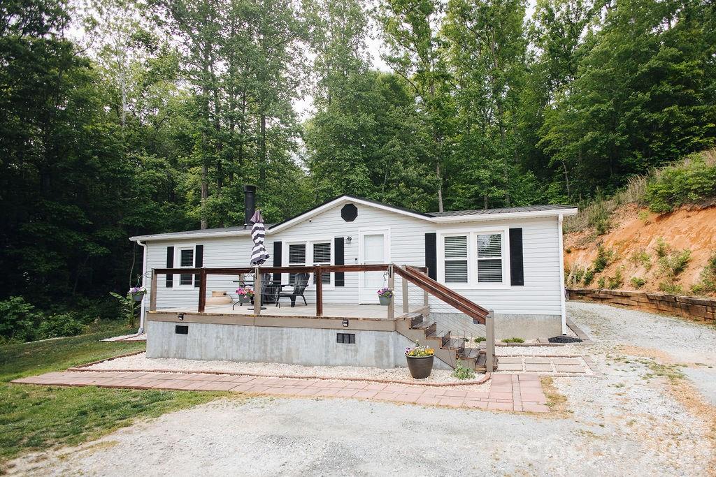 Tucked away in the beautiful mountains of Western North Carolina, this well maintained home offers the perfect balance of comfort, updates, and convenience all within an easy drive to Asheville, Marion, and I-40. Situated on a spacious lot with room to spread out, this property has been lovingly cared for and thoughtfully updated over the years. 

Inside, you’ll find updated flooring throughout much of the home, a cozy gas fireplace perfect for cool mountain evenings, and waterproof flooring in the bathrooms for added durability and style. The spacious primary suite easily accommodates a king sized bed and features a walk in closet along with a functional, comfortable layout designed for everyday living.

The home also offers a heat pump estimated to be approximately 6 to 7 years old and a roof that is only around 3 years old, giving buyers peace of mind on major systems. The property has been regularly serviced and well maintained, reflecting pride of ownership throughout.

Outside, enjoy relaxing mornings or evenings from the porch while taking in the peaceful surroundings. Two outbuildings remain with the property, including one previously used as a garage/workshop space, offering excellent storage, hobby, or workspace potential. The neighboring property currently utilizes a shooting range nearby, though it is not located on this property itself.

Conveniently located close to Asheville while still offering the charm and slower pace of mountain living, this property provides easy access to shopping, dining, outdoor recreation, and all the beauty Western North Carolina has to offer. Whether you are looking for a full time residence, mountain getaway, or investment opportunity, this home combines functionality, updates, and location into one inviting package.