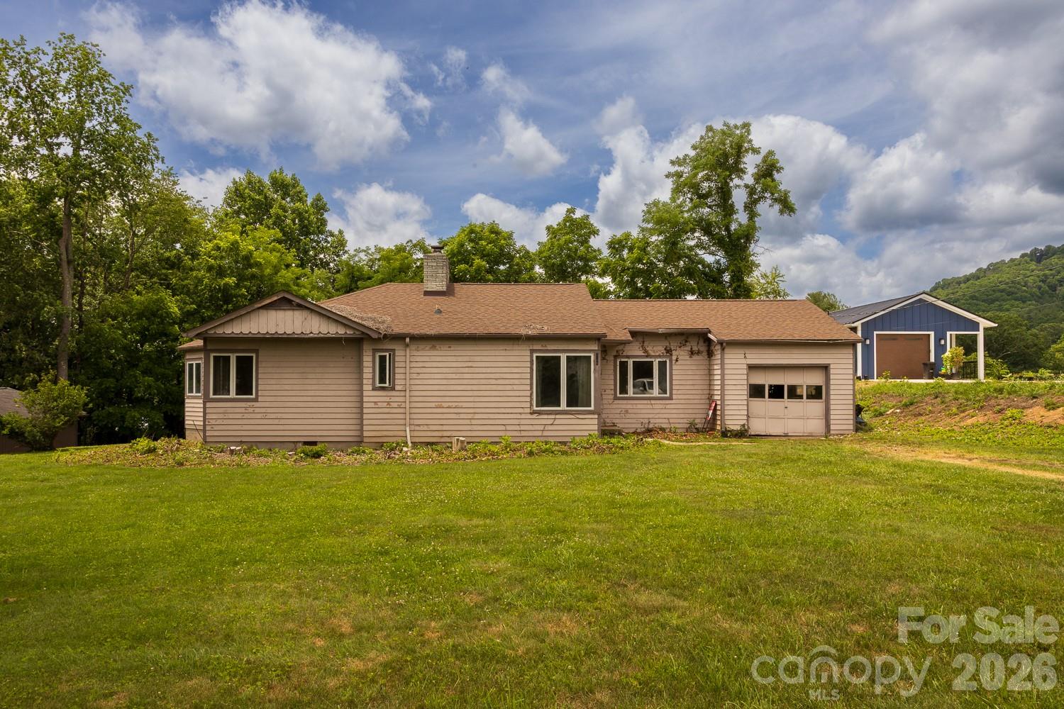 Builder and renovation opportunity near downtown Burnsville. This mid-century home has reached the stage where it needs a comprehensive rehabilitation, but it offers the location, lot size, and underlying structure that make restoration projects worthwhile. The home is vacant, accessible, and ready for evaluation by contractors, investors, and experienced remodelers.

Situated on a generous in-town parcel within walking distance of Burnsville's historic town center, the property lies within the footprint of the former Stanley McCormick School campus, an important part of Burnsville's educational history. Several historic buildings from that era remain nearby, lending the neighborhood a distinctive sense of character and connection to the town's past.

The home presents an opportunity to preserve and revitalize a classic 1950s residence while building equity through thoughtful improvements. Whether restoring its original charm or reimagining the space for modern living, buyers will appreciate the combination of location, history, and potential. Bring your vision, tools, and expertise—properties with this blend of historic context and renovation upside are becoming increasingly difficult to find.

Being sold as-is. Buyers are encouraged to conduct all inspections and evaluations necessary to determine suitability for their intended use.