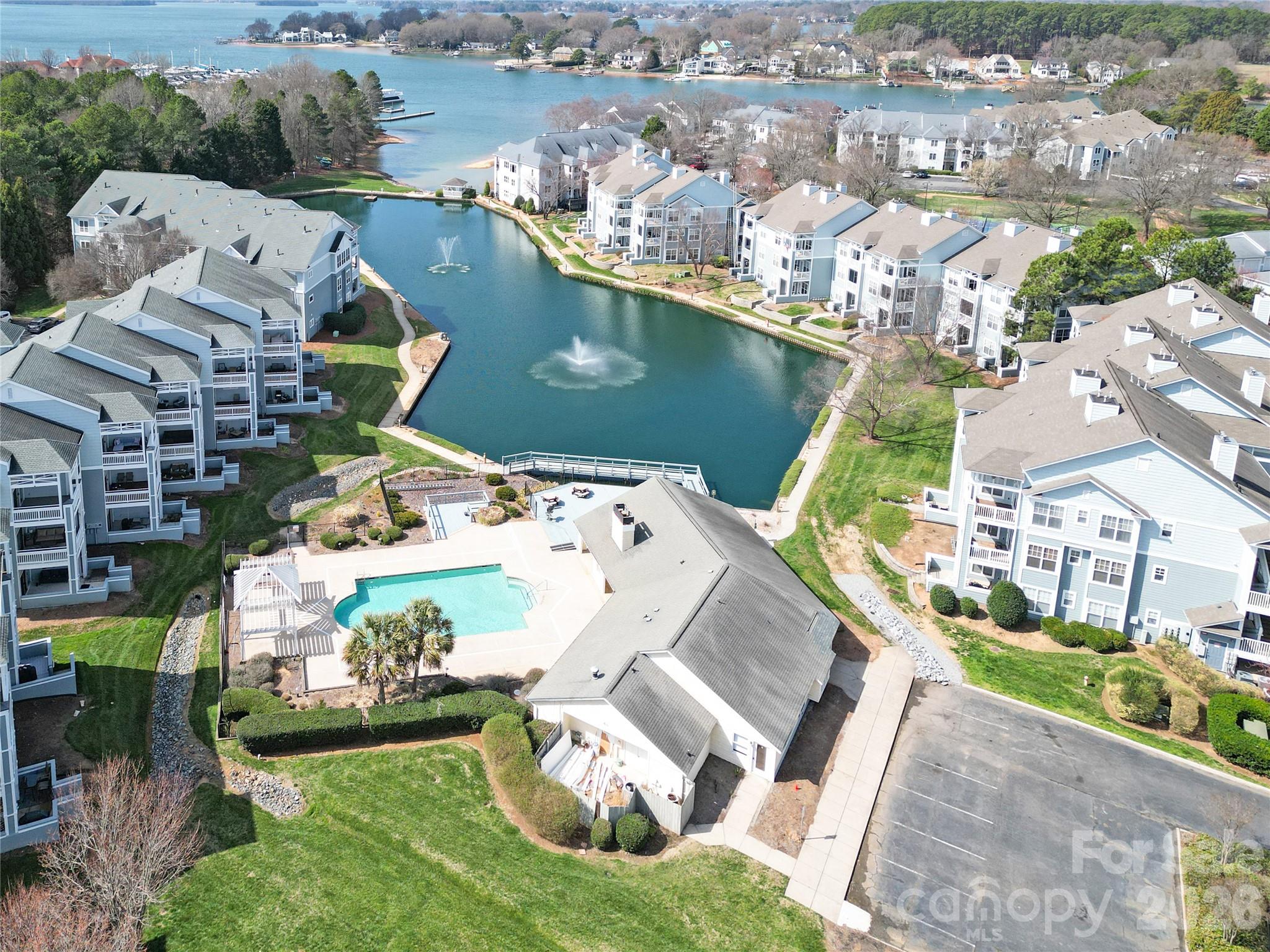 Wake up to beautiful water views in this inviting 2-bedroom, 2-bath condo designed for comfort and easy living with a new lower price! Wonderful open floorplan with granite countertops in kitchen and tile backsplash.  Spend your mornings sipping coffee, gazing upon the picturesque view of the water on your covered patio.  The thoughtfully designed split-bedroom layout offers privacy, a spacious primary bathroom with oversized tile shower and double top vanity.  Community sits on the beautiful Lake Norman with its very own beach and offers all amenities including tennis, pool, fitness room, kayak and boat launch.