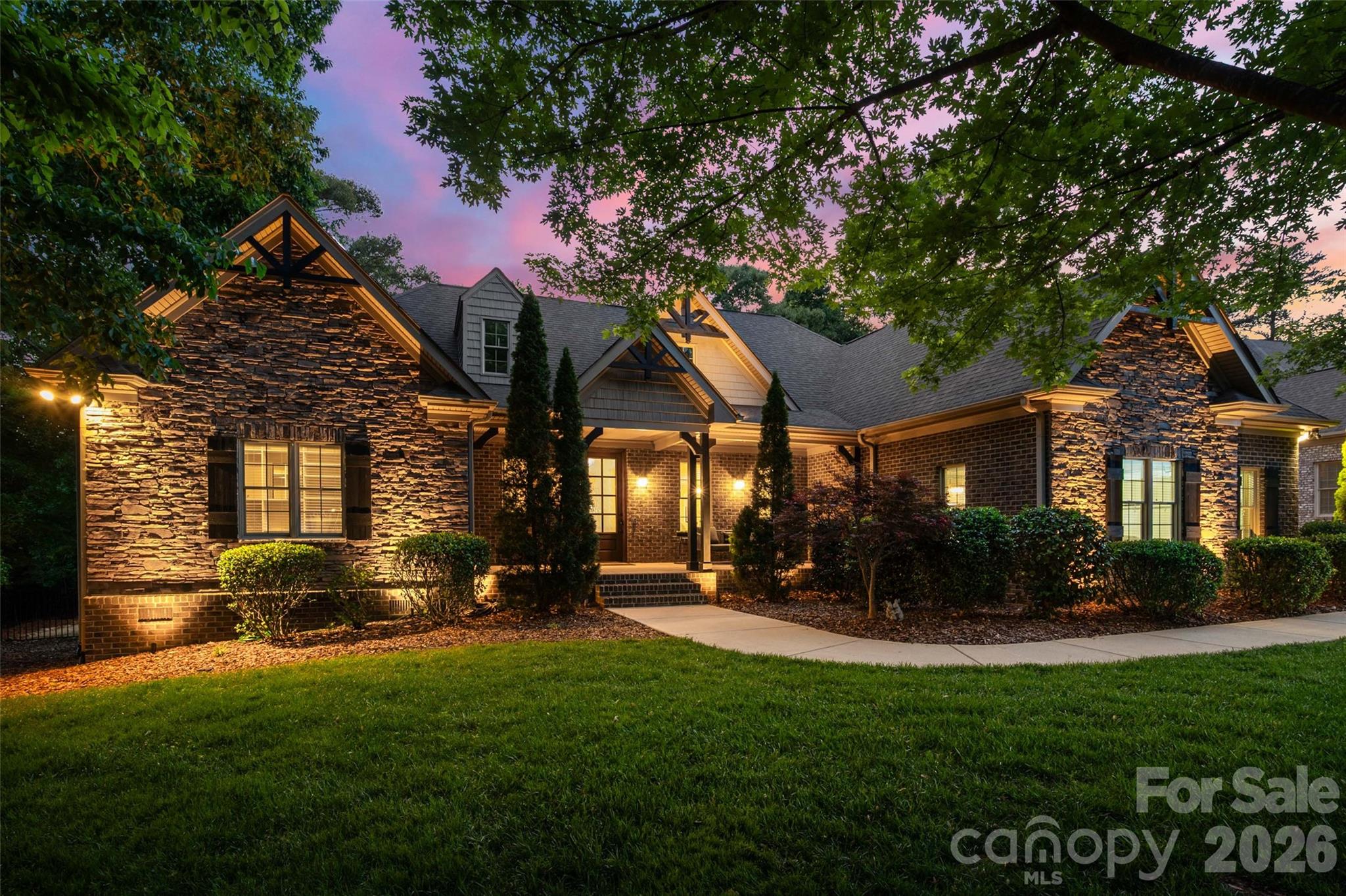 Elevate your lifestyle with a custom home in Stanton Heights. Conveniently located near the NC border with quick access I-485 and 15 minutes to the upscale Ballantyne area, this residence offers the rare advantage of lower SC property taxes while remaining moments from premier shopping, dining, entertainment, and everyday modern conveniences. Located in the award-winning Fort Mill School District, renowned for exceptional academic achievement and student success, this home offers luxury and lasting value. The timeless architecture of this full brick home is gracefully positioned on a spacious .46 acres parcel welcoming you with natural views of established trees and enhanced privacy. Natural sunlight pours inside as the dining room illuminates under the designer chandelier. French doors frame the picturesque view of the sparkling in-ground pool beyond. The heart of the home is the chef-inspired kitchen where culinary creativity comes alive. Gleaming hardwood floors guide you toward the oversized quartz island designed for gathering and conversations. Premium features including stainless steel double ovens, granite countertops, a gas cooktop with built-in downdraft, undermount cabinet lighting, and abundant cabinetry to blend beauty with exceptional functionality. Nearby, the light-filled sitting area offers endless versatility as a peaceful coffee lounge, music room, plant sanctuary, or elegant bar retreat. Anchoring the main living space is the floor to ceiling stone fireplace complimented by a coffered ceiling and statement ceiling fan. Retreat to the luxurious primary suite on the main level with private entry to panoramic pool views and enjoy the convenience of a wet bar where coffee at sunrise or wine at sunset becomes part of your daily ritual. The spa-inspired bathroom delivers a resort-like experience featuring heated floors, a jetted tub, tiled walk-in shower, and an impressive custom walk-in closet designed for comfort and elegance. Upstairs, two additional secondary bedrooms provide exceptional flexibility for guests, recreation, office space, or bonus living areas to fit your evolving lifestyle. The entertainment continues outside on the expansive rear covered deck equipped with dual ceiling fans and ambient lighting to enjoy under the sun or stars. Spend summer afternoons cooling off in the pool, unwind in the hot tub for a sauna experience, or transform the fenced side yard into a putting green, flower garden, or play area tailored to your vision. Complete with designer finishes, a tankless water heater, water softer, oversized 3-cars garage and generously sized walk in attic for extra storage. Every detail of this residence reflects custom craftsmanship and quiet luxury to serve as your forever home for generations to come. Tour this pristine beauty today!