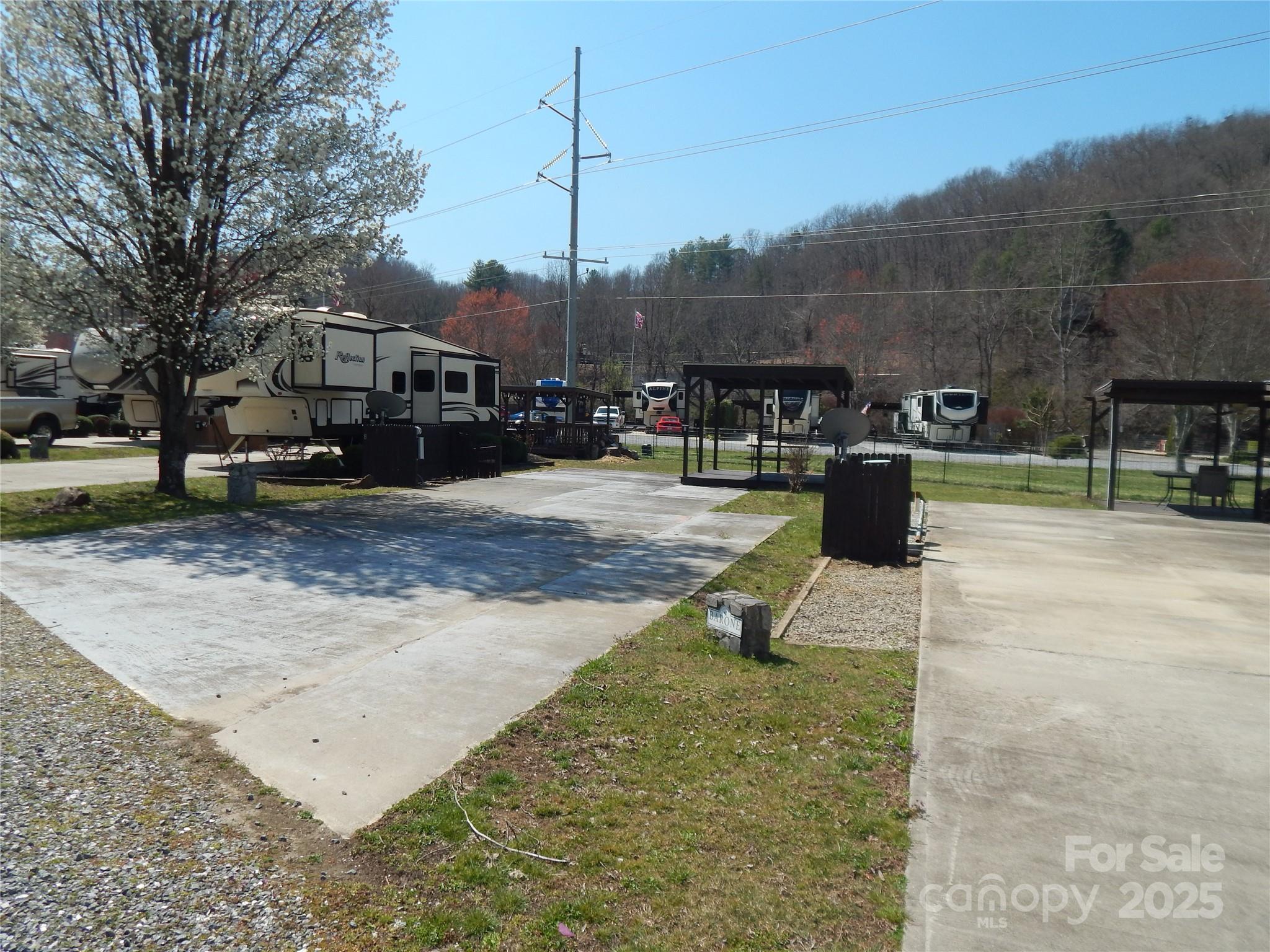 Lot 8 sits in pristine Savannah Creek RV Park, tucked in between a creek and an open field with mountain views. Perfect vacation spot to park your RV, kick back and relax in your mountain getaway. Conveniently located between  Sylva and Waynesville. Jump on the parkway to see the views or head to one of the beautiful local mountain towns to shop and dine. Close to Cataloochee Ski Slopes, Harrah's Cherokee Casino, and plentiful nature activities.