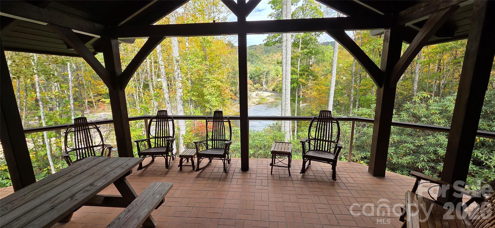 Experience the pinnacle of sustainable mountain luxury. Tucked away on 6 gently sloping, wooded acres, this spectacular 3-bedroom, 3.5-bathroom custom wood cabin perfectly balances self-sufficiency with upscale architectural design. Surrounded by a vibrant, mature forest canopy, this private retreat is an outdoor enthusiast’s dream, featuring direct access to world class trout fishing on the renowned South Toe River.
The property boasts an exceptional, fully independent infrastructure designed for effortless off-grid living. A solar panel array situated discreetly beside and above the garage handles daily power generation, completely backed by a heavy-duty propane generator for seamless redundancy. Drink in the pure, crisp taste of the mountains with a pristine, gravity-fed spring water system that provides natural water pressure without relying on an electric pump, complemented by a fully permitted private septic system.
Architecturally striking, the cabin features dramatic prow front windows, a soaring timber-framed covered deck, beautiful stone accents, and a massive solid-rock foundation profile that anchors the home into the hillside. Inside, the spacious 3-bed, 3.5-bath layout offers ample room for hosting family or operating a high-end vacation rental. Whether you are casting lines into the crystal-clear South Toe River, relaxing on the expansive elevated deck, or enjoying the warmth of the wood-finished interior, 165 Winding Trail offers a rare lifestyle of absolute freedom, privacy, and natural beauty.
Feature Highlights
Premium Waterfront Location: Immediate access to top-tier trout fishing on the highly coveted South Toe River.
The Land: 6 private, gently sloping acres covered in beautiful mountain hardwoods and mature canopy trees.
Elite Off-Grid Infrastructure:
Pure Water Source: Gravity-fed mountain spring water system supplying crisp water with natural pressure.
Private septic system installed.
The Cabin: Masterfully built post beam construction accented with beautiful stone work cabin featuring 3 bedrooms, 3.5 bathrooms, a dramatic vaulted porch overlooking a major bend in the South Toe River giving you panoramic views of the river, skylights, and premium elevated views.