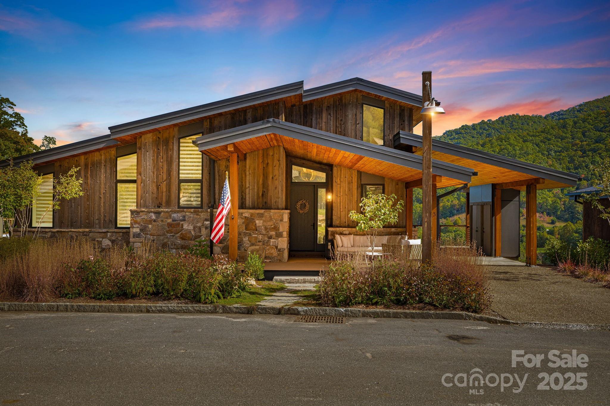 A Mountain Modern Masterpiece at Balsam – Elegance and serenity converge in this architectural treasure, completed just two years ago and designed to capture both the beauty of the mountains and the ease of refined living. This stunning two-story residence offers three indulgent bedroom suites with a stunning custom-designed bunk room, making it perfect for hosting loved ones in comfort and style. Walls of glass invite the outdoors in, showcasing uninterrupted views across Balsam’s picturesque driving range. The interiors are adorned with high-end finishes, bespoke craftsmanship, and timeless design elements that elevate every detail. Soaring ceilings, an open-concept layout, and carefully curated materials create a seamless blend of warmth and sophistication, while expansive living areas are made for both intimate gatherings and grand entertaining.  Just a short stroll from the clubhouse and pro shop, the location balances luxury with convenience. This home has been thoughtfully crafted as the ultimate lock-and-leave retreat, offering low-maintenance living without compromise. Whether it’s a long mountain escape or a weekend getaway, the setting inspires a slower pace and deeper connection.  At Balsam, this residence is more than a home—it is a sanctuary where every season brings new beauty, and every stay creates lasting memories.