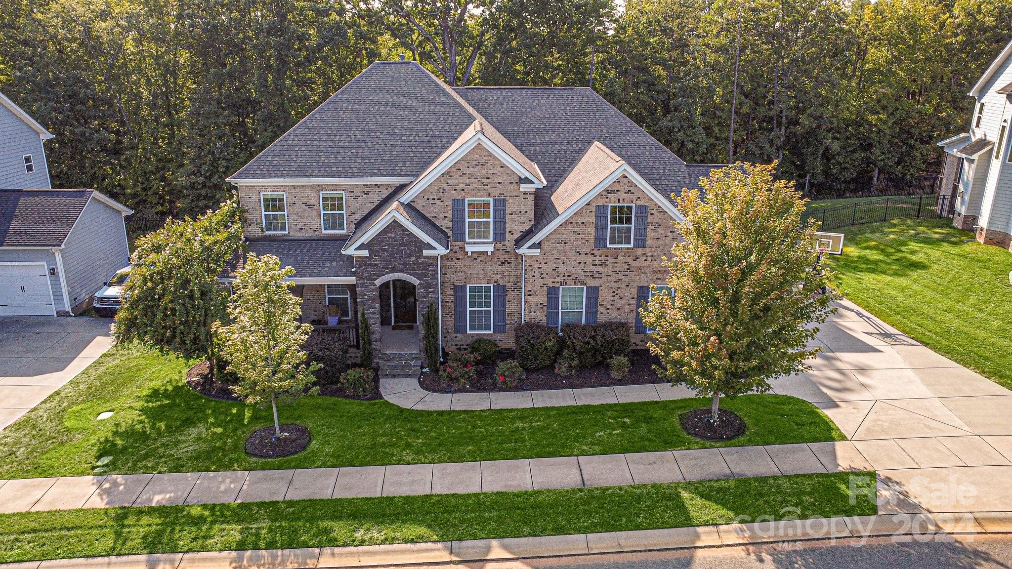 This amazing Alpine floorplan offers formal living & dining,open kitchen,lots of cabinets & counter space,Butler's Pantry & open 2-story Family & Morning room w/ 2 fireplaces.Custom sliding doors from the Morning room open up onto a beautiful covered and enclosed porch with a wooded view. This elegant home has arches & tons of trim details.The primary bedroom is located on the main floor and has a gorgeous en-suite,double vanities,tub,shower and closet.Upstairs has 3 Bedrooms and 2 full bathrooms and a large bonus room and an extra bonus space in one of the bedrooms.At the top of the steps you will find flex space that allows for desk work that overlooks the beautiful living space below.Exterior outfitted with JellyFish permanent lighting.Massey has wonderful amenities including olympic sized pool with lazyriver and water slide,clubhouse,fitness room,greenspace,playgrounds,firepits.Close to restaurants/shopping you will love the convenient location.Award winning schools! VirtualPoolPic