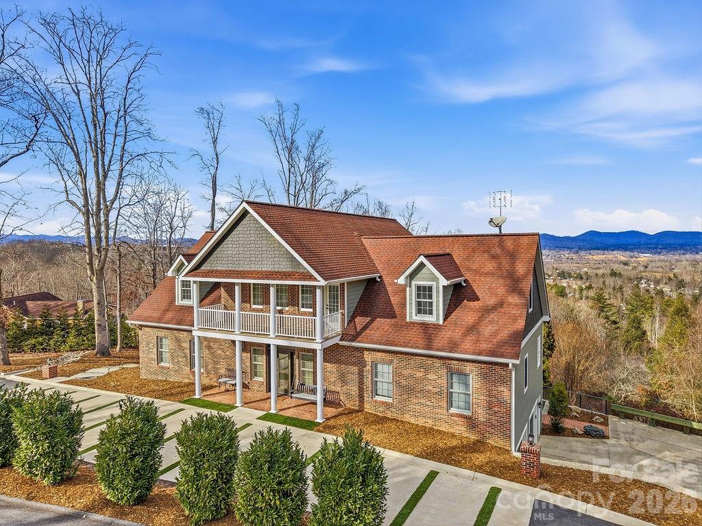 This exceptional 4,964 sq ft residence blends luxury, comfort, and thoughtful design in a truly fantastic location. Showcasing expansive mountain views, the home is designed to maximize both scenery and livability, with outstanding indoor and outdoor spaces throughout.
A circular drive creates a grand arrival, while an elevator provides seamless access to all three levels—perfect for convenience and long-term living. The home is ideal for entertaining, featuring beautifully designed outdoor spaces and an outdoor kitchen, all surrounded by professionally landscaped grounds with low-maintenance turf grass. No lawn mower is needed.
Car enthusiasts and guests alike will appreciate the ample parking and storage, including a 1200 sq ft three-car detached garage plus two additional attached garage bays. A home generator adds peace of mind, ensuring comfort and reliability year-round.
From the breathtaking views to the functional luxury details, this property offers a rare combination of elegance, practicality, and location—1.5 miles to Advent Health's Hospital and 5 miles to the Asheville Regional Airport.