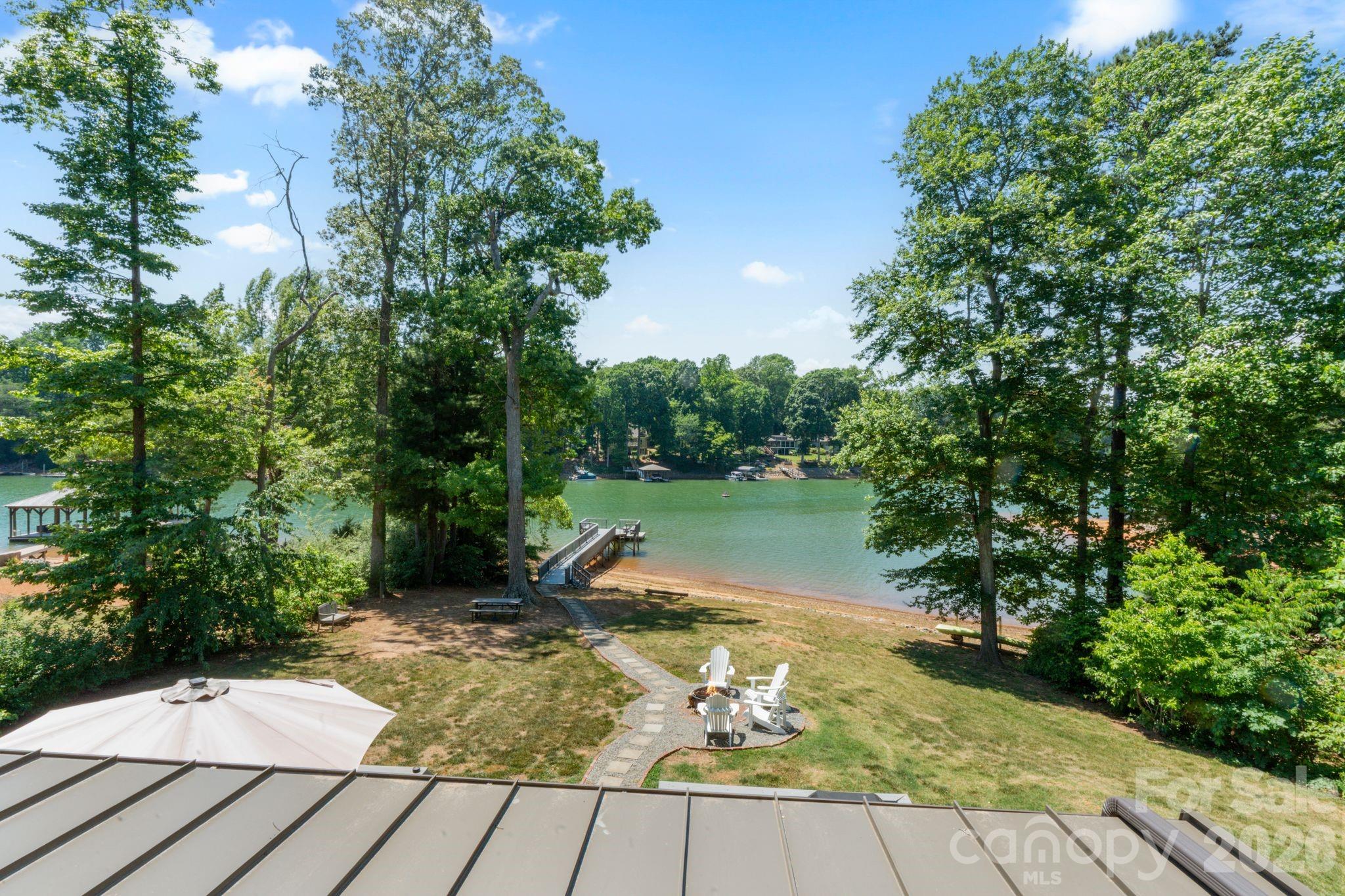 Welcome to a Lake Norman waterfront opportunity, tucked away on a quiet deep-water cove with easy access to the main channel.  Currently existing home on the land can be used as rental income while you plan your dream Lake Norman retreat and get permits in place. Outback is an existing firepit area with seating, open water views, and an oversized lakeside deck and floating dock perfect for relaxing, entertaining, swimming, and enjoying the waterfront lifestyle.  Additional highlights include, private well, recently updated 4 bedroom septic, exterior storage shed, no HOA, ample parking space, and a beautifully maintained waterfront setting surrounded by mature trees for added privacy and charm.  Located in highly desirable Mooresville, this Lake Norman location offers quick access to dining, marinas, shopping, golf courses, highway access and everything that makes lakeside living so special. Whether you’re searching for a full-time residence, weekend getaway, or investment opportunity, this property delivers the perfect opportunity to make your waterfront living dreams come true!