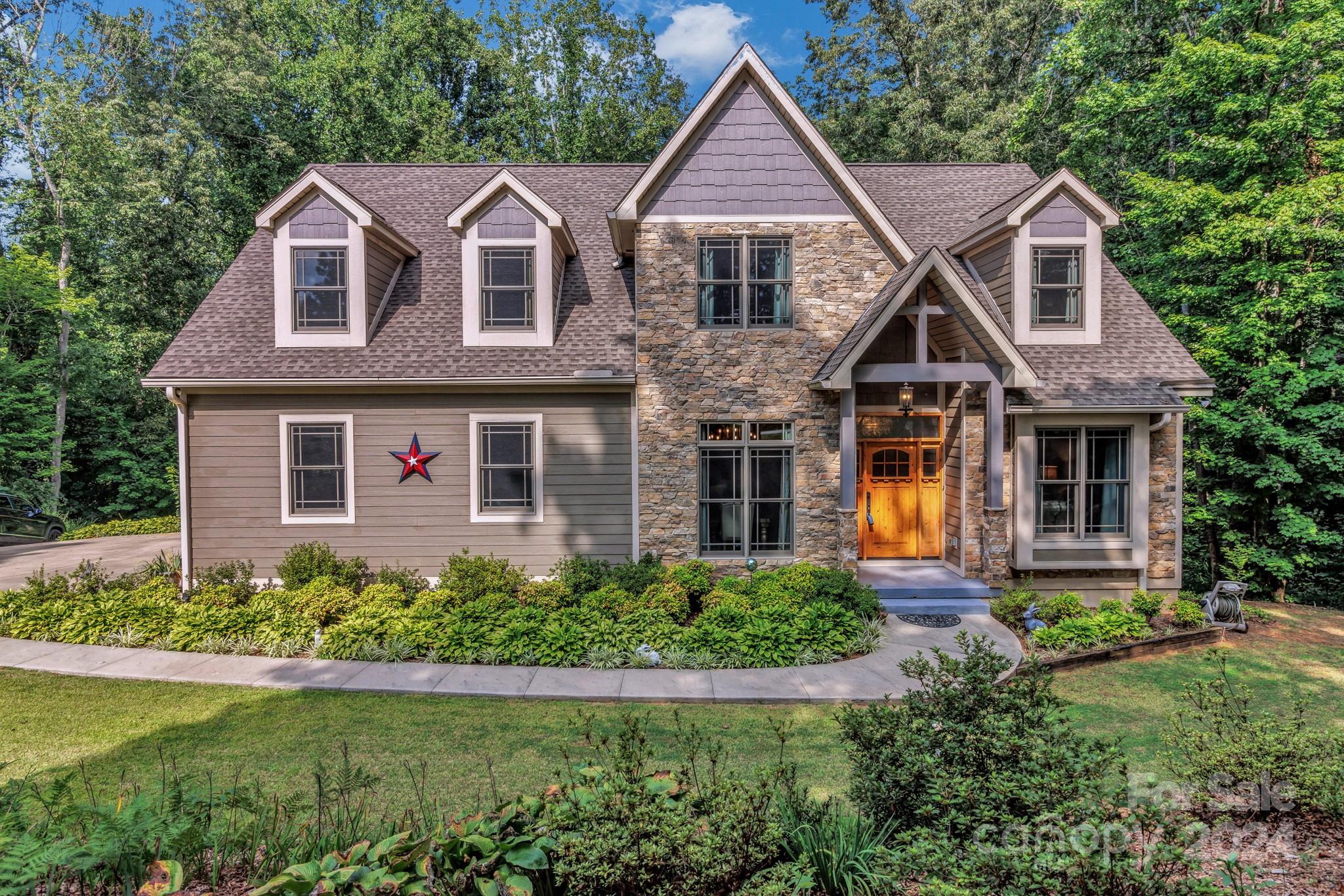 Welcome to your private oasis in the heart of Candler! This stunning, craftsman home boasts over 5.5 expansive acres of serene, wooded beauty, offering both tranquility and seclusion while still being conveniently close to local amenities. From the moment you arrive, you’ll be captivated by the impressive curb appeal of this modern masterpiece. The residence features a thoughtfully designed open floor plan with abundant natural light, creating a warm and inviting atmosphere. The gourmet kitchen is a chef’s dream, complete with stainless steel appliances, custom cabinetry, and a generous island perfect for meal preparation and casual dining. The adjacent living room, with its elegant fireplace and access to the deck, provides a perfect space for both relaxing and entertaining. The home offers a primary bedroom and office on the main floor. 2 bedrooms upstairs (one ensuite) with 2 bonus rooms. The basement offers a blank canvas for you to finish, plumbed for a kitchen and bathroom.