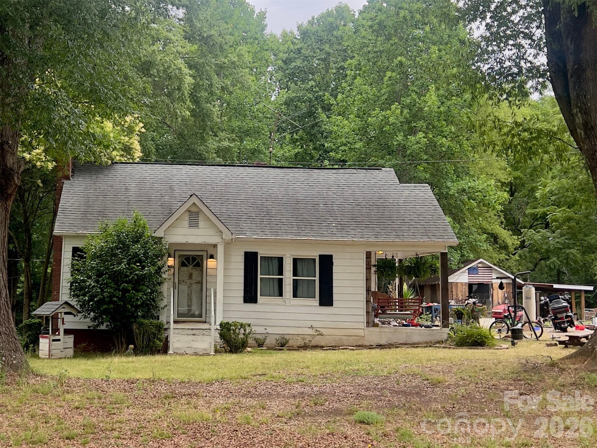 An exceptional opportunity to own a country estate consisting of 11.68+/- acres. Located in the Sherrills Ford community of Catawba County, this 1940s cottage-style home features 2 bedrooms and 1 bathroom with a covered porch! The property around the home is cleared with mature trees, and the majority of the land in a dense forest of hardwoods and native pines. This property has municipal water & sewer and the ability to create a bigger vision for a private, luxury estate, an equestrian farm or recreation hunt camp, or even develop into a residential subdivision.
