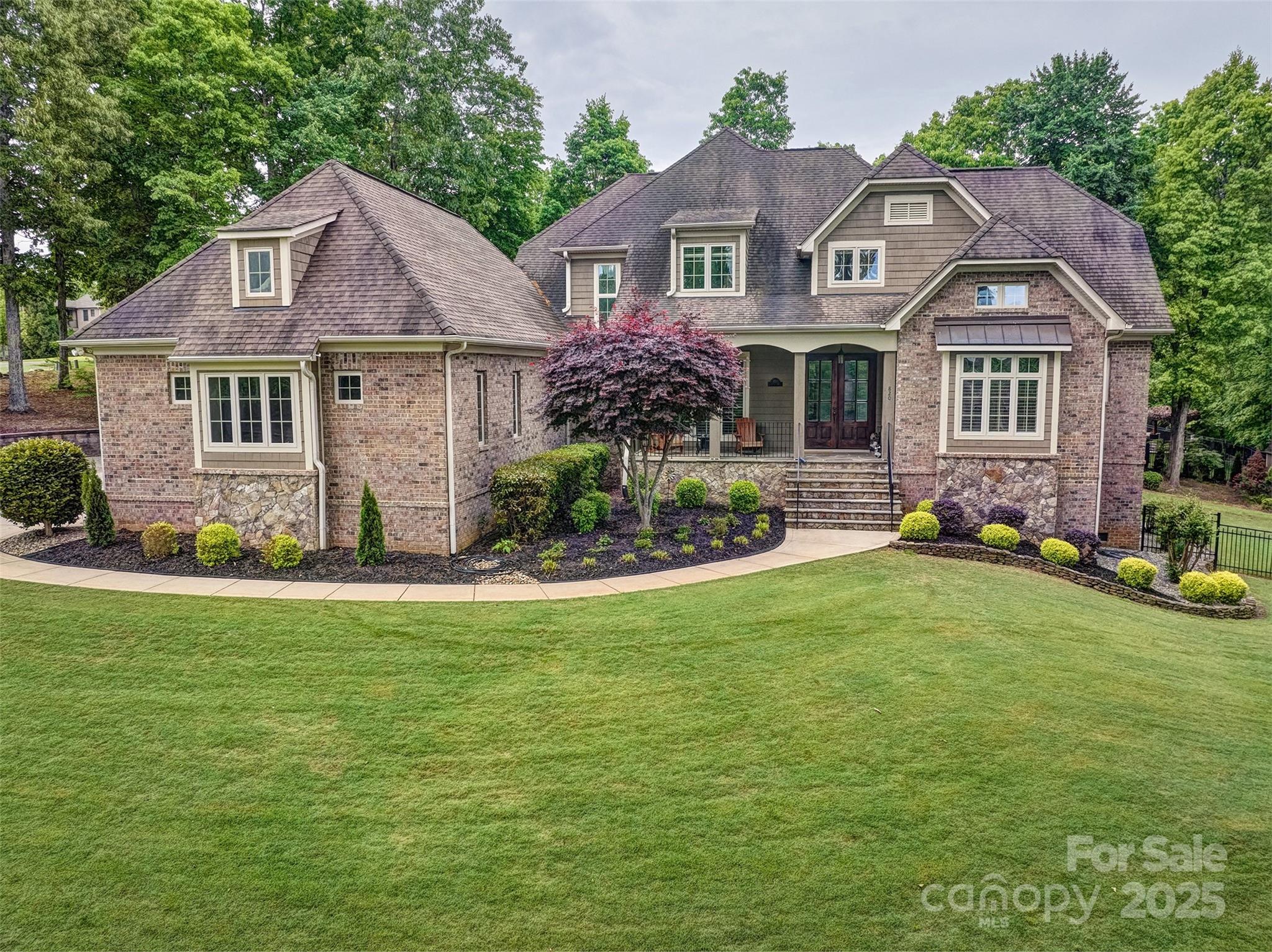 Welcome home to this beauty and all that living in Lake Wylie offers.Low SC taxes,award winning Clover School system &convenient to everything.Easy commute to Charlotte,Rock Hill,Gastonia & airport.Awesome large home with room for the family!Located in 1 of the premier neighborhoods in the area with all acre+ lots and executive brick and stone homes.This one offers 4 bedrooms,4 full bathrooms & 1/2 bath. Great open floorplan with high end touches of coffered ceilings in the great room, stacked stone fireplace, so much counter space in the kitchen, beautiful quartz counters and laundry room that you won't mind working in &storage for days. Oversized Primary bedroom on the main floor offers access to the screened porch and great outdoor living, sitting room and spa like bathroom.Paver patio and coi pond finish the backyard look.Each bedroom has an ensuite bathroom upstairs and huge bonus room. The crawl space has cement floor for even more storage or multiple uses. Oversized 3 car garage