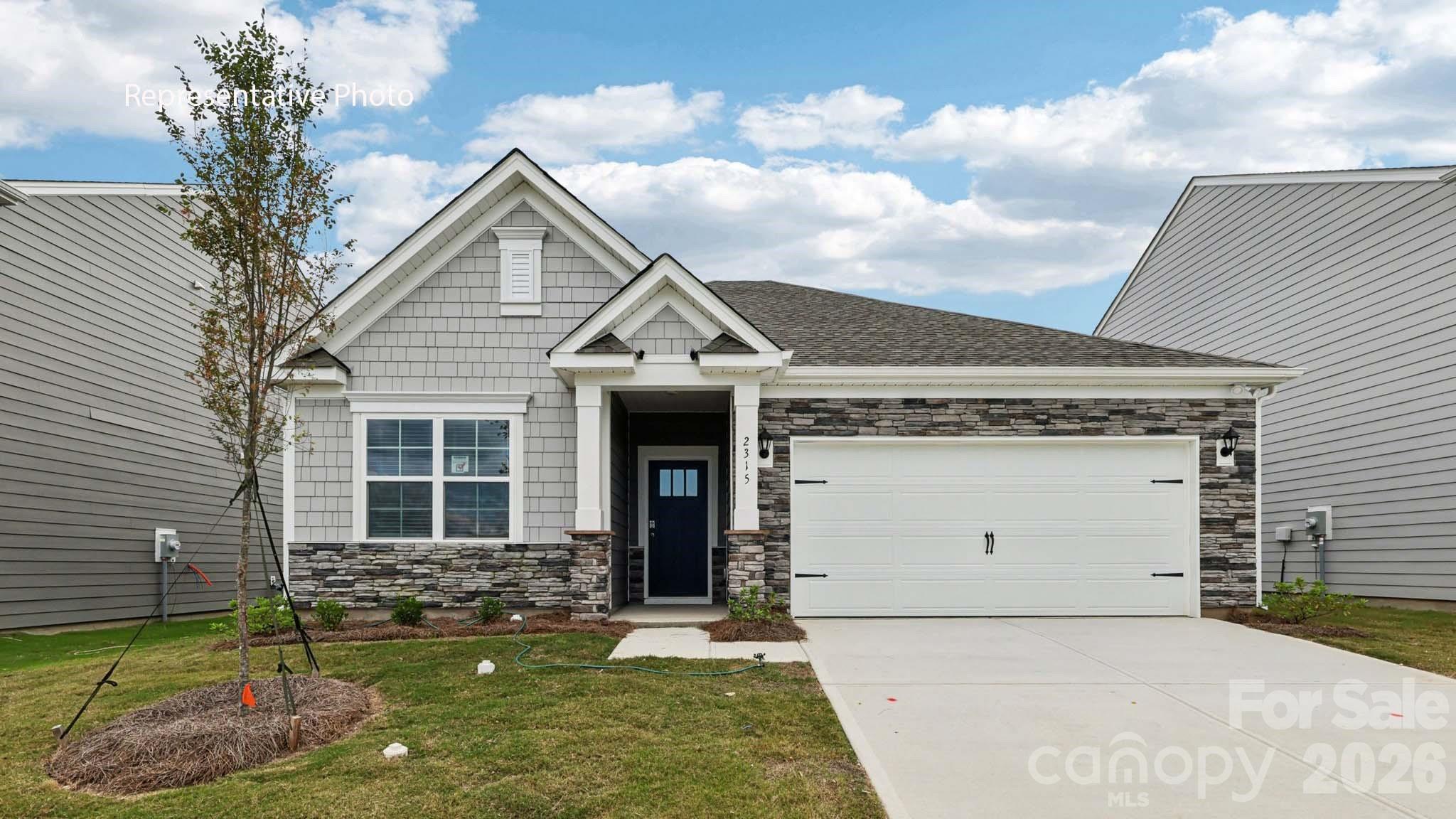 This Aria home features three bedrooms, two full bathrooms, and a two-car garage. An inviting foyer greets you upon entering, leading directly into the heart of the home. The open plan features a family room with gas fireplace, dining room, and kitchen designed with the home cook in mind. The kitchen is equipped with a pantry, stainless steel appliances, and a large island with a breakfast bar, making it perfect for both dining and casual entertaining. A luxurious primary suite, complete with a large walk-in closet, dual vanities, and spacious shower. The additional two bedrooms and secondary bathroom are located at the opposite end of the home, providing optimal privacy for all. Exit the dining area onto a covered porch that is perfect for outdoor entertaining. With its thoughtful design, the Aria is the perfect place to call home in the Lake Norman's hidden gem zip code 28673 in Sherrills Ford.