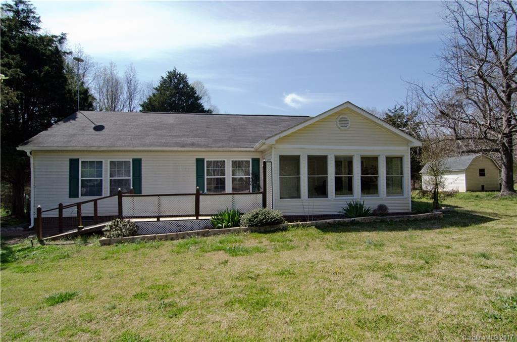 3.52 ACRES, over 1.5 acres fenced pasture. Maintained 2 or 3 bedroom (a wall can be added for the 3rd bedroom)  Small barn, wired workshop, storage building , waterfall & Stocked spring fed pond in the back w/zip line, several fruit tress line the property. Outside water supply from pond.
