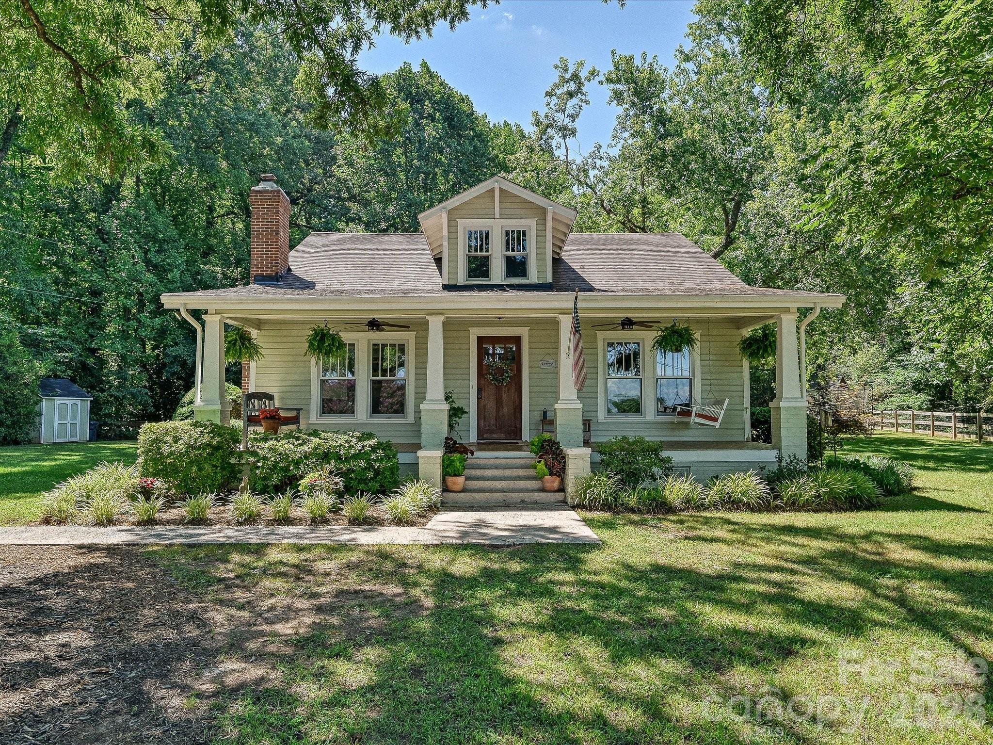 Beautifully renovated and full of southern charm, this inviting home welcomes you with a covered rocking chair front porch and sits on a private, level 0.67-acre lot with a fenced backyard surrounded by mature trees. Inside, abundant natural light fills the thoughtfully designed floor plan, showcasing newly refinished hardwood floors (2021) throughout the main living areas. The beautifully remodeled kitchen is the heart of the home, featuring quartz countertops, a large center island with seating and storage, farmhouse sink, stainless steel appliances, a gas range with vent hood, and timeless finishes. The spacious great room offers a cozy gas fireplace, while the main-level primary suite provides a peaceful retreat with a stunning renovated ensuite featuring dual vanities and a beautifully tiled walk-in shower. A custom coffee bar adds both style and function to the dining area, creating the perfect spot to start your day. Upstairs, you'll find two generously sized secondary bedrooms and flexible living space. Outside, enjoy the expansive backyard, oversized deck, and tranquil setting - ideal for entertaining, relaxing, or simply enjoying the privacy of this beautifully landscaped property. This one is a true MUST SEE!