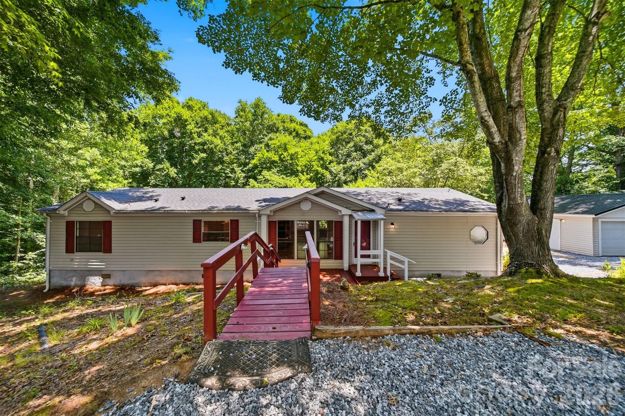 Freshly renovated and move-in ready! This updated home offers nearly 1,800 sq ft of living space with 3 bedrooms, 2 full baths, and a bonus room. Situated on approximately 2.25 acres, the property features a detached 2-car garage with power and a new metal roof, plus a circular driveway with new gravel. Interior updates include new laminate flooring throughout, LVP flooring in wet areas, fresh neutral paint, updated bathrooms with new vanities and toilets, and an updated kitchen featuring new stainless steel appliances, butcher block countertops, and tile backsplash. Enjoy the covered rear deck overlooking the wooded lot, relax around the fire pit area, or explore the creek that runs along the back of the property. Conveniently located just minutes from shopping, dining, and grocery stores. FHA, VA, USDA, or Conventional financing accepted. Schedule your showing today!