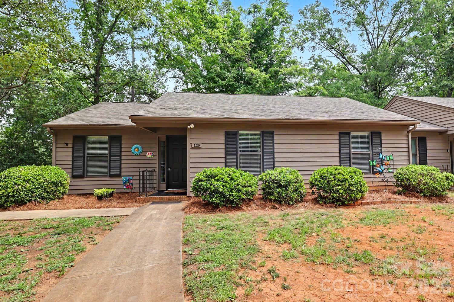 Welcome home to this Fabulous end unit condo in the Dogwood Hills Community.  There are 3 spacious bedrooms and two full baths.  Enjoy the walk in closets in all the bedrooms for great storage.  You will enjoy the open floorplan with a white kitchen and look through island.  There is granite counter tops, tile backsplash, stainless appliances, new microwave, new range and new light fixture in the kitchen. New LVP flooring throughout, no carpet !! Bathrooms are updated with tile. The dining area looks out to a relaxing screened in porch to enjoy the private backyard.  There is new flooring throughout and paint.  New HVAC in 2025.  The HOA has painted the exterior and a new roof has been done within the last few years.  Convenient to restaurants, shopping and I77 for your commute.  This condo is ready for a quick close if need be.  Come check out this spacious , move in ready home and make it yours !!