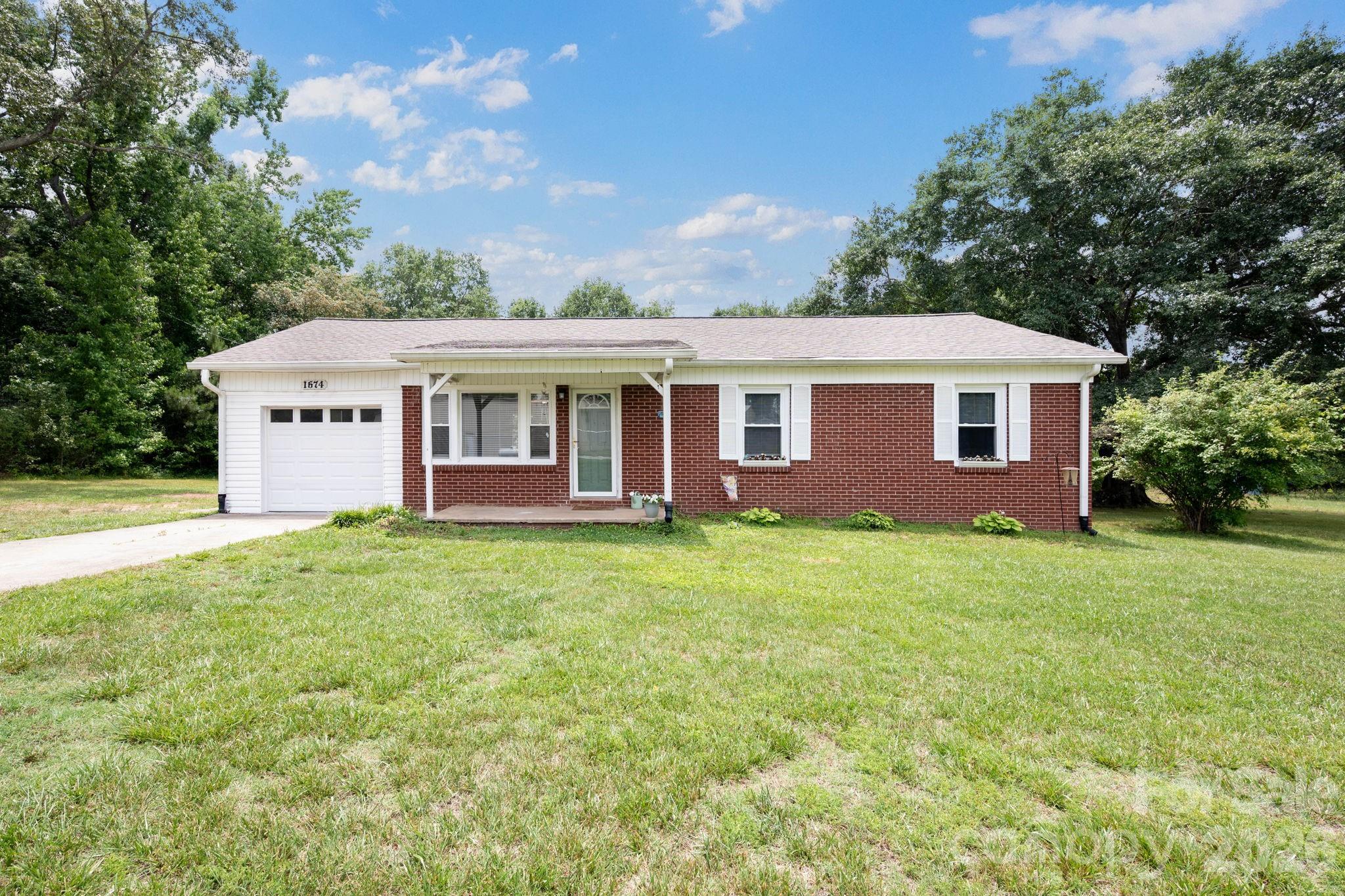 Welcome home to this charming brick ranch nestled in the desirable Harris community. Offering 3 bedrooms, 1.5 baths, this move-in ready home combines classic character with modern updates. Inside, you'll find a bright and inviting living area, an updated kitchen with ample cabinet space, a dedicated dining area, and fresh, neutral finishes throughout. The spacious bedrooms provide flexibility. Outside, enjoy a large yard with plenty of room for entertaining, gardening, pets, or simply taking in the peaceful surroundings. An attached garage adds convenience and additional storage. Conveniently located just minutes from Forest City, Rutherfordton, shopping, dining, and everyday amenities, this well-maintained home offers the perfect blend of country charm and accessibility. Don't miss your opportunity to make this beautiful property your own!

Disclosure: A support jack is present beneath a floor support beam in the crawl space. Sellers did not install the jack and have no knowledge of the reason for its installation, when it was installed, or whether it was associated with any prior structural repairs. No supporting documentation is available. Buyers are encouraged to perform their own due diligence and inspections. **Sellers will have foundation/beam repair completed July 21st. It will include a transferrable lifetime warranty.