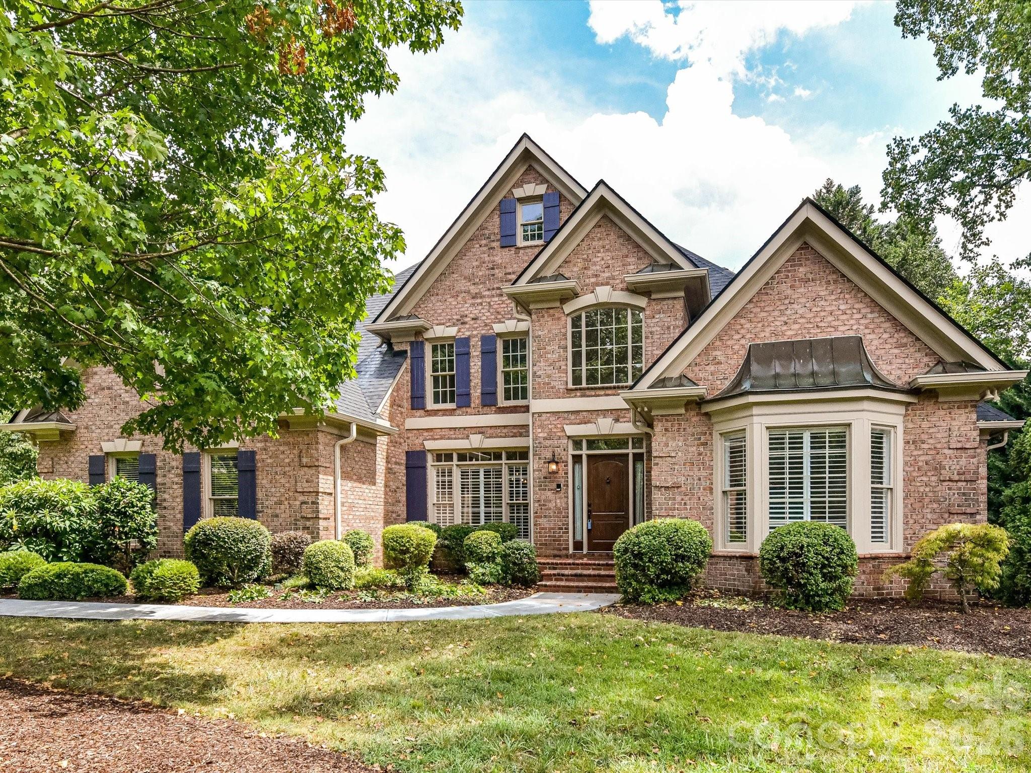 Rosecliff is a sought-after enclave of brick homes set on beautifully wooded homesites in South Charlotte—close to shopping, dining, and recreation, yet with a peaceful, tucked-away feel. Lovingly maintained by the current owners for more than 30 years, 4409 Rosecliff Drive has been thoughtfully refreshed for its next chapter with freshly interior paint and refinished hardwood flooring.The main-level primary suite offers a stunning spacious retreat with coffered ceilings, a sitting area with a cathedral ceiling, and a gas fireplace accented by a custom stone mantle. The renovated primary bath features generous vanities, porcelain sinks, granite countertops, a deep soaking tub, and an expansive step-in shower. The foyer is framed by a formal dining room and living room, offering elegant spaces for entertaining or a flexible home office setup. The open floor plan flows beautifully from the formal entry into the step-down great room, where French doors open to a gracious terrace. The kitchen includes a large center island, granite countertops, and stainless steel appliances. Nearby, the laundry area adds everyday convenience with built-in cabinetry and a utility sink. The second level offers three additional bedrooms, two Jack-and-Jill baths, and a fifth bedroom or bonus room. A large walk-in attic provides ample storage space. Enjoy low HOA fees of $200 per year and a convenient location near the Arboretum, Stonecrest, Trader Joe’s, and the Four Mile Creek Greenway. Recent updates to this home include HVAC and Architectural Roof.