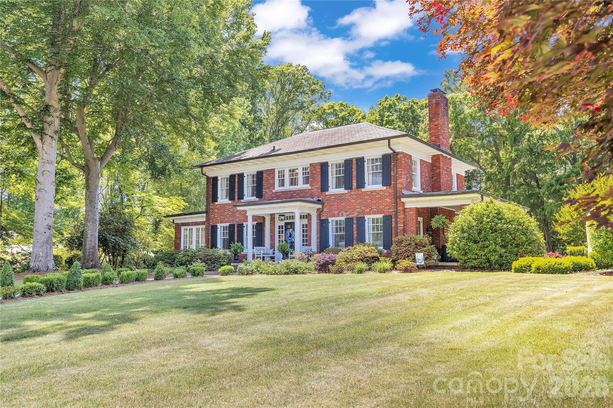 Prepare to fall in love from the moment you step through the front door of this truly extraordinary home located in one of Historic Salisbury’s most treasured neighborhoods. Rich architectural details, exceptional craftsmanship, and beautifully updated living spaces combine to create a residence that feels both timeless and luxurious.

The breathtaking foyer immediately sets the tone with elegant frieze molding, gleaming hardwoods, and stunning beveled glass pocket doors that open into the gracious living room. This remarkable space features a handsome fireplace, custom accent wall, incredible built-in cabinetry, and two sets of beveled glass French doors opening to the expansive covered side porch. Natural light pours throughout the home, enhancing the warmth and sophistication found in every room.

Designed for both elegant entertaining and comfortable daily living, the dining room is beautifully scaled and opens into a charming sun porch complete with built-ins and a window seat — the perfect spot for morning coffee, reading, or quiet conversation.

The kitchen is simply exceptional. Thoughtfully renovated while respecting the character of the home, it offers a Viking 6-burner range with griddle, dual dishwashers, GE Monogram refrigerator, oversized island with storage, abundant cabinetry, and designer finishes throughout. The adjoining bar area includes beverage refrigerator, ice maker, sink, and additional storage, creating a seamless entertaining experience. A cozy keeping room beside the kitchen invites family and guests to gather while meals are prepared.

The music room is both elegant and inviting, opening directly onto the incredible covered side porch that feels like an outdoor living room. Beyond lies one of the property’s most magical features — the professionally designed side garden with white archway, mature landscaping, stone pathways, firepit, and multiple seating areas that create an atmosphere rarely found.

Ascending the stately staircase, the architectural half landing provides space for artwork, seating, or a reading nook. The primary suite is a true retreat featuring separate his-and-hers closets, including an extraordinary dressing-room-style closet that feels like its own private boutique space. The newly renovated primary bath is stunning with dual vanities, spacious walk-in shower with seat, beautiful tilework, and additional storage.

Bedrooms two and three are generously sized with a Jack-and-Jill bath, while bedroom four includes its own ensuite half bath. Exceptional built-ins and storage solutions are found throughout the home.

The professionally engineered waterproofed basement offers tremendous flexibility with workout space, hobby or craft areas, and abundant storage. Above the detached two-car garage, a finished heated and cooled bonus space creates wonderful options for office, studio, recreation, or guest overflow. A rear porch and half-court basketball area further enhance the property’s lifestyle appeal.

The grounds are absolutely spectacular — expansive, private, and meticulously maintained with mature landscaping and irrigation. Additional features include invisible fencing, generator, security system, and countless thoughtful details that make this home one of Historic Salisbury’s truly special offerings.