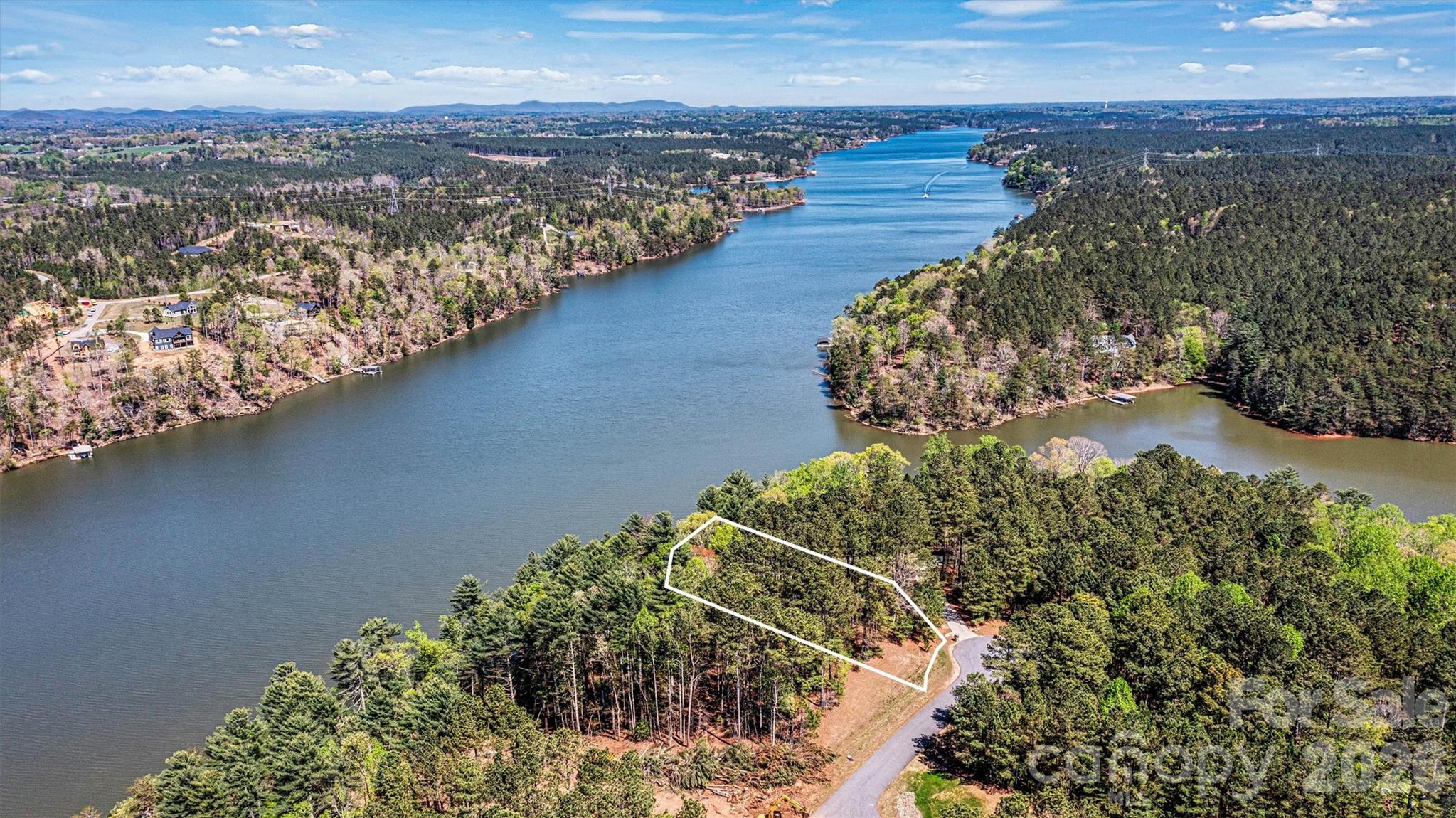 Harbor Ridge - 106 Pier Point - 1.13 Acre Lakefront Lot - 141.5' Lake Frontage 
Discover the perfect canvas for your dream home on this lakefront lot in the gated Harbor Ridge community. This 1.13-acre parcel offers main channel living on Lake Rhodhiss, a hidden gem known for its tranquil waters, quiet coves, and recreational opportunities—ideal for boating, fishing, kayaking, or simply soaking in the natural beauty. Lake Rhodhiss is a favorite among nature lovers and those seeking a peaceful retreat with year-round enjoyment. Harbor Ridge is an established lakefront community offering residents secure gated access, boat storage, day docks, and more.  A lovely opportunity to create a custom lake retreat where mornings begin with sunrise views and evenings end with serene sunsets. Don’t miss this opportunity to live lake life to the fullest—where community, nature, and convenience meet.  Close proximity to I-40 - ideally situated for travel to Hickory, Charlotte & Asheville.