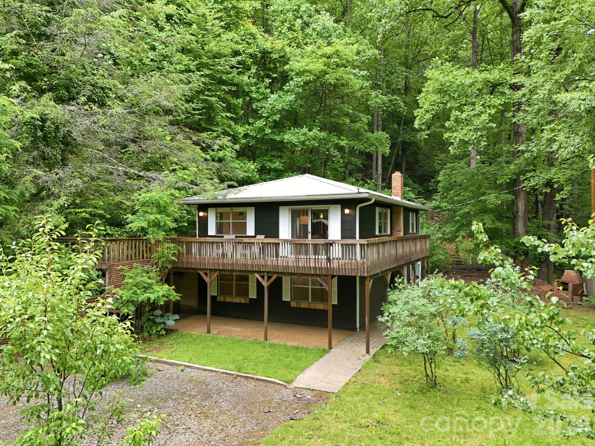 Embrace the simple life. This charming property perfectly blends a rustic exterior with a warm,
inviting interior. Designed for outdoor living, the expansive wrap-around deck offers access from
three sides of the home, while a dedicated spur walkway leads to a peaceful detached sitting
area. Nestled on over 20 entirely wooded acres, the property is surrounded by vibrant, native
flora, ensuring complete privacy.
A standout feature is the massive detached garage—an ideal space for parking, a pottery
studio, a woodworking shop, or automotive hobbies. For added convenience, the home can be
purchased fully furnished. Situated with excellent proximity to the Blue Ridge Parkway, it’s an
outdoor enthusiast's dream. Enjoy easy, year-round access via fully paved roads, offering plenty
of space to bring your boat, RV, or camper. Whether you are seeking a part-time mountain
retreat or a full-time residence, this exceptional home is a must-see.