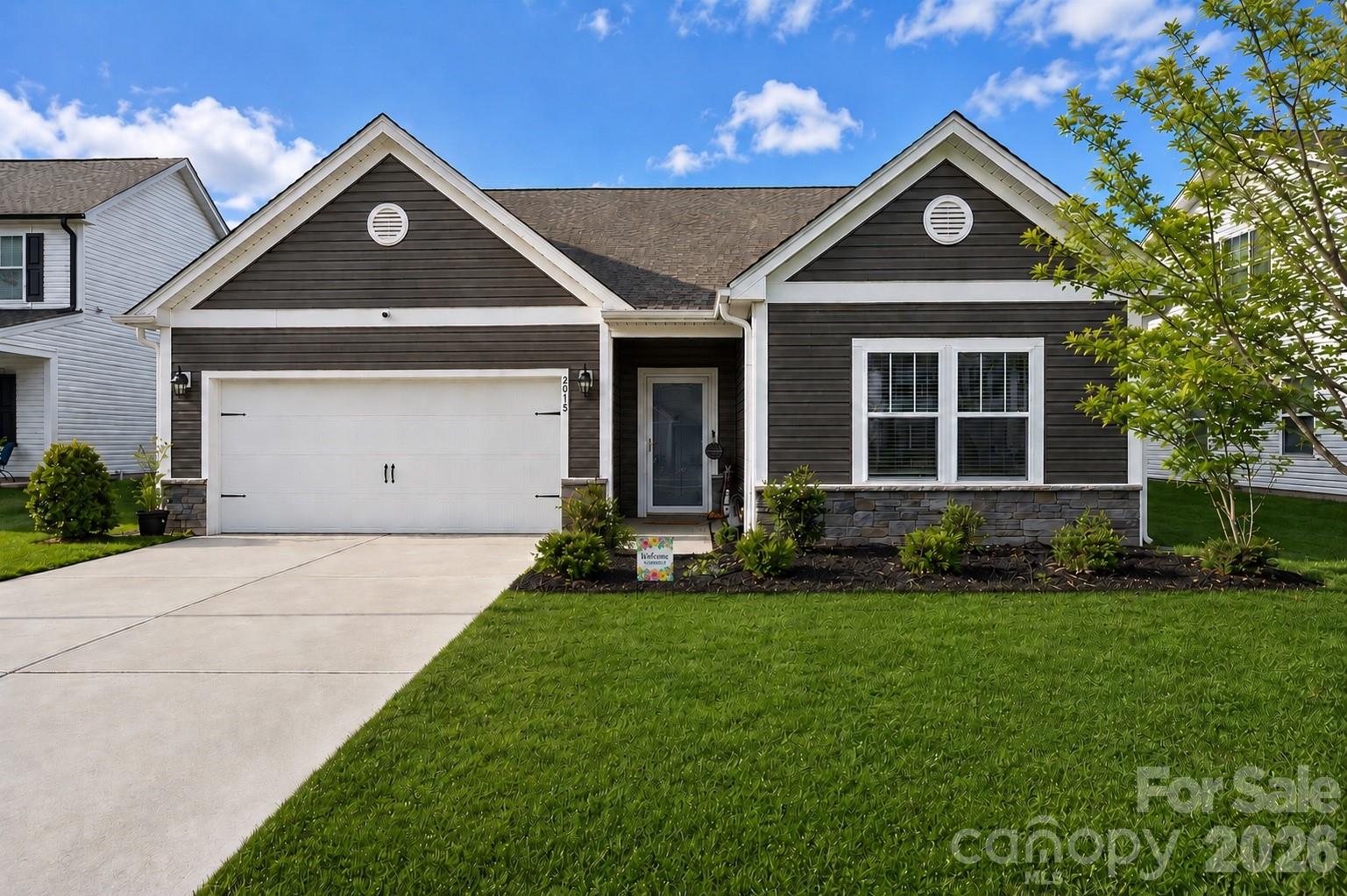 Welcome home to this beautiful 2022 ranch located on a quiet cul-de-sac in Western Stanly Co. Offering effortless one-story living, a bright open floor plan, and a layout designed for both everyday comfort and entertaining. The generous sized Great Room and Kitchen serve as the heart of the home, with the Great Room showcasing a cozy wood-burning fireplace that creates a warm and inviting atmosphere. The Kitchen is ideal for gathering with family and friends, offering an oversized island, quartz countertops, tile backsplash, abundant prep space, and a roomy pantry. Whether you’re hosting holiday dinners or a lively Bunco night, the Dining Room provides the perfect setting for everyday meals and special occasions alike. Luxury vinyl plank flooring flows throughout the main living areas, combining style with durability. The thoughtfully designed split-bedroom floor plan offers three bedrooms, including a private primary suite tucked away at the rear of the home for added privacy. The spacious Primary Suite features a luxurious bath complete with a tiled shower, dual vanities, linen closet, and walk-in closet. Step outside and enjoy your own backyard retreat! The expansive concrete patio with a stunning epoxy finish is perfect for entertaining, whether it's relaxing under the Pergola or enjoying the top of the line Caldera Paradise salt freshwater Hot Tub/Spa with a freshwater IQ water monitor. This checks pH, chlorine, and salt levels and provides clear instructions to keep water balanced. The large, fully fenced backyard offers plenty of space, privacy, and endless possibilities for outdoor enjoyment!!  If you enjoy drinking clean water, the home also includes a whole house water purification & softener system ($7k value)