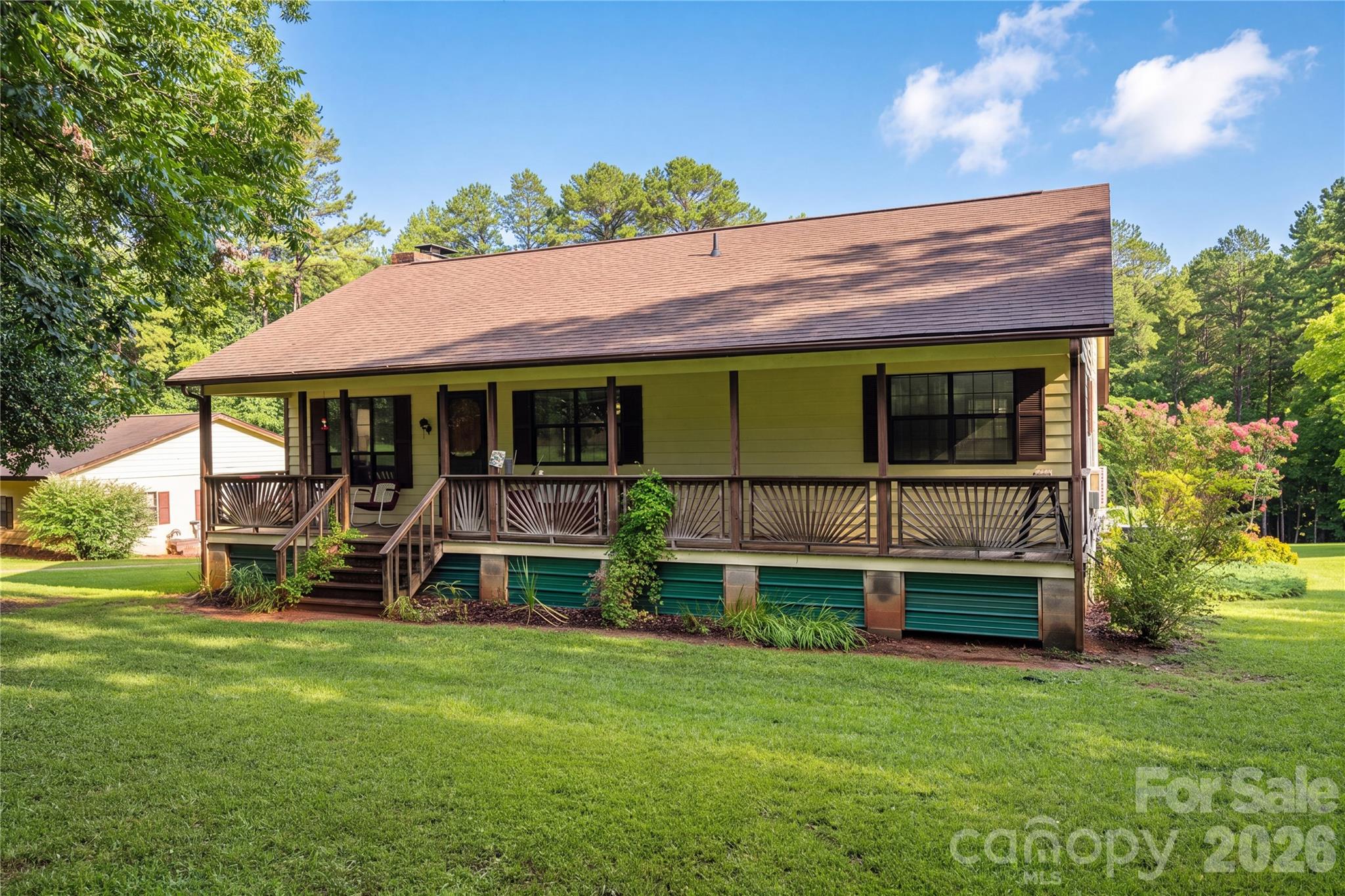 Imagine starting your mornings with coffee on the front porch and ending your evenings unwinding on the back porch, surrounded by the peace and quiet of over 10 beautiful acres. Offering the perfect blend of cleared and wooded land, this pristinely maintained property invites you to slow down, spread out, and enjoy country living. The charming 2 bedroom, 2 bath home offers over 1100 square feet of heated living space on the main level, including a soon to be newly completed primary bathroom. Both the covered front and back porches extend the full width of the home, creating wonderful spaces to relax, gather and enjoy the view. Downstairs, more than 1100 square feet of unfinished basement space offers endless possibilities for future living space, recreation, hobbies or storage. Outside you'll find a fenced pasture, a large detached two car garage with space for hobbies or potential home-business use and additional outbuildings for storage. Tucked away from traffic yet conveniently located to Charlotte, Lincolnton, Denver, Stanley, Mount Holly, Huntersville and Cornelius, this special property offers something increasingly hard to find: space, privacy, possibility and a quieter way of life.