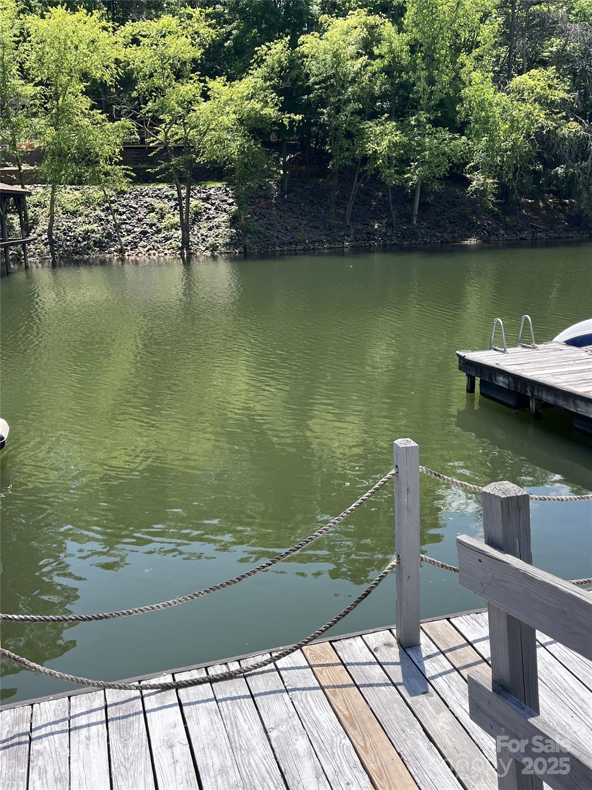 Live the Lake Wylie lifestyle in this beautifully updated 3BR/2.5BA Tega Cay peninsula home with direct water access, neighborhood dock, and deeded boat slip—perfect for boating and water enthusiasts. Skip the marina hassle and enjoy lake days right from your backyard. Features include a main-floor primary suite, vaulted ceilings, custom shelving, quartz kitchen countertops, new stainless appliances, and modern bathrooms w/ marble & walk-in tile showers. A spacious upstairs flex room can serve as a 4th bedroom, office, or gym. Upgrades: new LVP flooring, lighting, roof, HVAC, gutters, interior/exterior paint, and epoxy garage floor. Walk to Windjammer Park and enjoy Tega Cay amenities: golf, pickleball, pool, and award-winning Fort Mill Schools. Close to Charlotte (16 mi), Uptown (18 mi), and Whitewater Center. Ditch the marina fees—Lake Wylie boating begins at your doorstep -  kayaking, paddle boarding, water skiing or trail walking -  opportunity awaits!