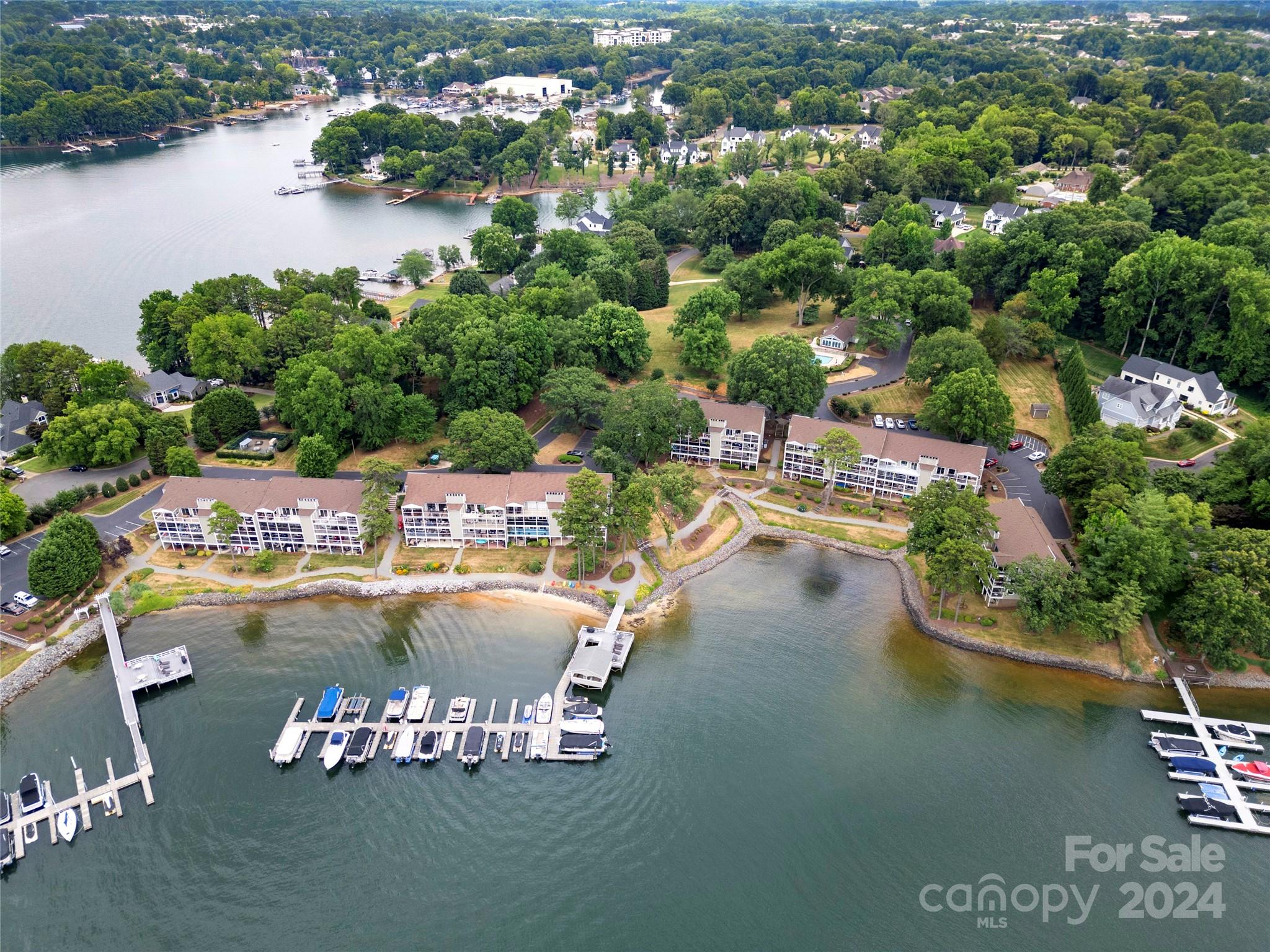 This immaculate WATERFRONT MOVE-IN READY, Condominium with assigned Boat Slip #13 on LAKE NORMAN is located in the Harborgate Condominium Complex in Cornelius. Hardwood floors (2021), both Bathrooms updated, Kitchen Cabinets Updated. S/S Appliances. Enjoy the big views of Lake Norman on the spacious covered balcony with two accesses, one from the Living Room and one from the primary bedroom.
Primary + full bathroom and walk-in closet + second bedroom with nice closet space on the Main Level.
Laundry room on main level. Enjoy a bonus family/flex room with lots of closet storage and built-ins on the lower level + bedroom/flex option with built-ins also on lower level. Lower level offers a sliding glass door walk-out to a porch steps away from the lake and boat dock.  A lovely beach area for swimming, kayak/paddleboard launch + gazebo for social meet-ups and outdoor grilling. Swimming Pool + Clubhouse. HOA includes water.  Sunrise & Sunsets await you! *Jet Ski Lift does not convey.