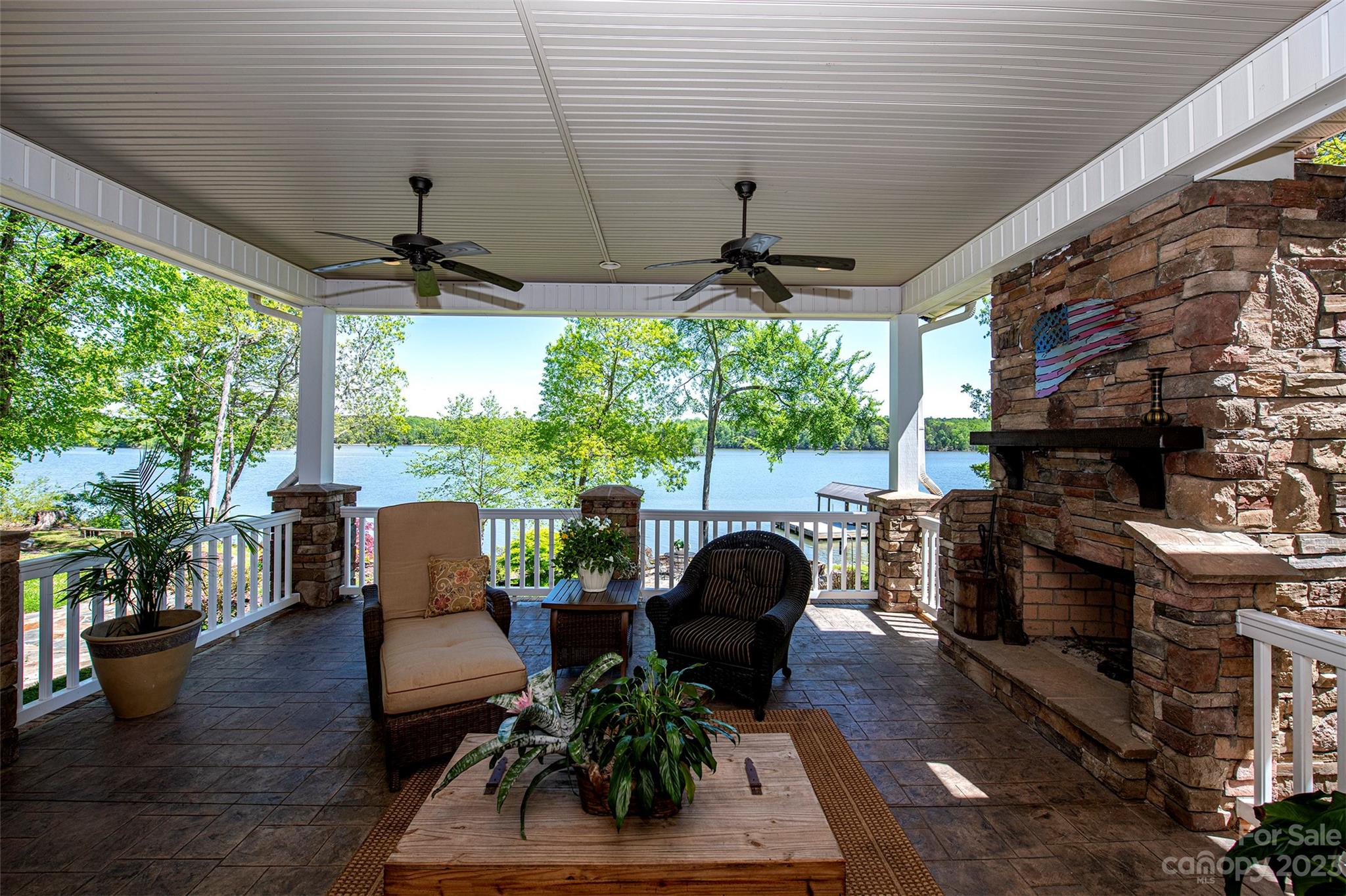 WATERFRONT property with spectacular views of the Catawba River. This Brick and stone custom ranch sits on 2.73 Acres w/800 feet of waterfront. Dock is over 1,000 SQFT w/power boat lift & metal roof. Outdoor living at it's finest w/800 SQFT covered porch, stamp concrete, ceiling fans, stone fireplace & TV mount. Also, at waters edge a 700 SQFT stone patio, w/firepit. Home features 10 foot ceilings, 8 foot doors, w/heavy moldings, hardwood & tile throughout. Kitchen boasts custom cabinets, granite, honed limestone backsplash, stainless appliances, pendant lights, wine bar w/glass fronts, and walk in pantry w/wood shelving. Great room w/gas fireplace, built-in's & ceiling fan. Primary bedroom w/stunning lake views, separate Men's height vanities, granite counters, tile shower w/frameless surround. His & Her closet w/Built in's. Laundry has custom cabinets, tile backsplash, mud sink, clothes chute & wood counters. 10x12 outbuilding. Lot was combined to 1 parcel, can be split & does perk.
