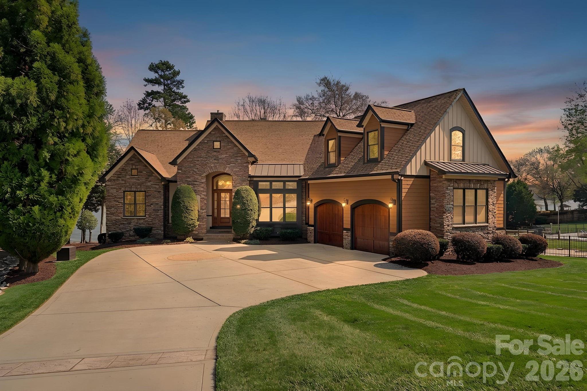 Waterfront living at its BEST! Panoramic water views from most rooms of this impeccably maintained home sitting in the midst of a garden-like lawnscape.  Outdoor living areas include expansive covered veranda, deck and screened porch with low maintenance Trex material. All of this overlooking 140' of shoreline, stone retaining wall, lounging/picnic area and covered stationary boat slip with automatic lift. Hardwood floors throughout the spacious main level, primary suite situated away from high traffic area with huge bath featuring dual vanities, jetted tub, large custom tile shower and dual walk-in closets.  Great room with wall of windows, coffered ceiling, stacked stone fireplace is an obvious "Welcome Home" once you walk through the main entrance of this beauty! The same wall of windows flows directly into the breakfast area and kitchen continuing to bring the outside in!  Gourmet kitchen with built-in appliances, granite countertops including pass window to great room.  Large laundry room, cabinets with counter space, great drop zone area, washer and dryer stays.  Secondary bedroom on main level is currently used as a flex space, office, dining room...you decide! Lower level contributes two additional bedrooms, a safe room, great bar area for entertaining and large storage room for lake toys.
