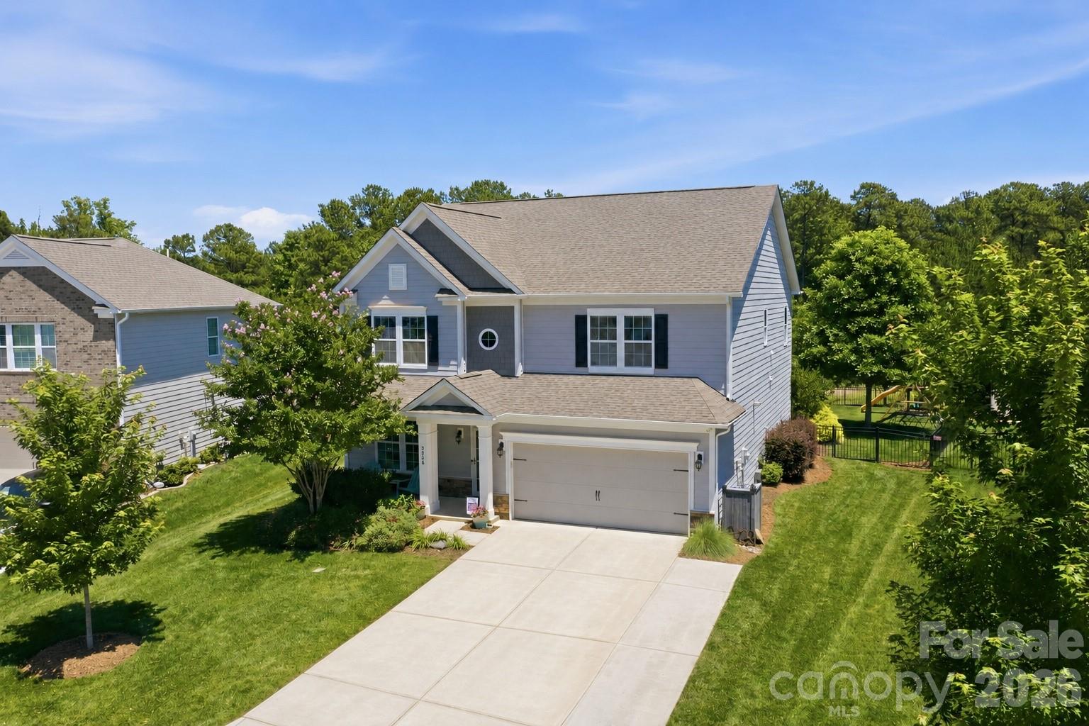 Welcome home to this beautifully upgraded 4-bedroom, 3-bathroom two-story residence located in the highly desirable Covington at Lake Norman community. Nestled in a picturesque tree-lined setting just minutes from Lake Norman, this exceptional home offers the perfect blend of luxury, comfort, and convenience with easy access to dining, shopping, boating, and top-rated Lincoln County schools. The inviting floor plan offers a desirable main-level guest suite with adjacent full bath, plus a versatile flex room perfect for a home office, study, or playroom. At the heart of the home, the stunning chef's kitchen showcases a large center island, modern shaker-style cabinetry with sleek black hardware, custom pendant lighting, oversized subway tile backsplash, under-cabinet lighting, and an expansive butler's pantry with additional walk-in storage. The open-concept design flows seamlessly into the living and dining areas, creating the perfect space for entertaining and everyday living. Upgraded pre-finished hardwood floors span the main level, complemented by Craftsman-style trim, custom lighting, upgraded faucets, a gas log fireplace, and more than 20 additional recessed lights throughout the home. A convenient drop zone with built-in cubbies welcomes you from the attached two-car garage, while added utility sinks in both the laundry room and garage provide extra functionality. Upstairs, you'll find a massive loft area offering endless possibilities for a media room, game room, or secondary living space. One secondary bedroom features unique custom hanging beds, while the luxurious primary suite serves as a true retreat with a tray ceiling, custom lighting and ceiling fans, a private sitting area accented by custom sliding barn doors and built-in bookcases, and a spa-inspired ensuite bath. The primary bathroom boasts a massive walk-in shower with dual shower heads and a frameless glass enclosure.
Outdoor living is equally impressive with a custom covered rear porch overlooking a fully fenced backyard complete with three access gates. A stick-built storage shed on a basement foundation provides exceptional storage and workspace options. Beyond the home itself, residents enjoy outstanding neighborhood amenities including boat storage, a clubhouse, competition-style pool with water features, and a spacious playground, creating the ideal setting for recreation, relaxation, and community gatherings. With its extensive custom upgrades, thoughtfully designed living spaces, sought-after amenities, and prime location near Lake Norman (including a public boat launch nearby), this meticulously maintained home presents a rare opportunity to enjoy the very best of Denver, NC living.