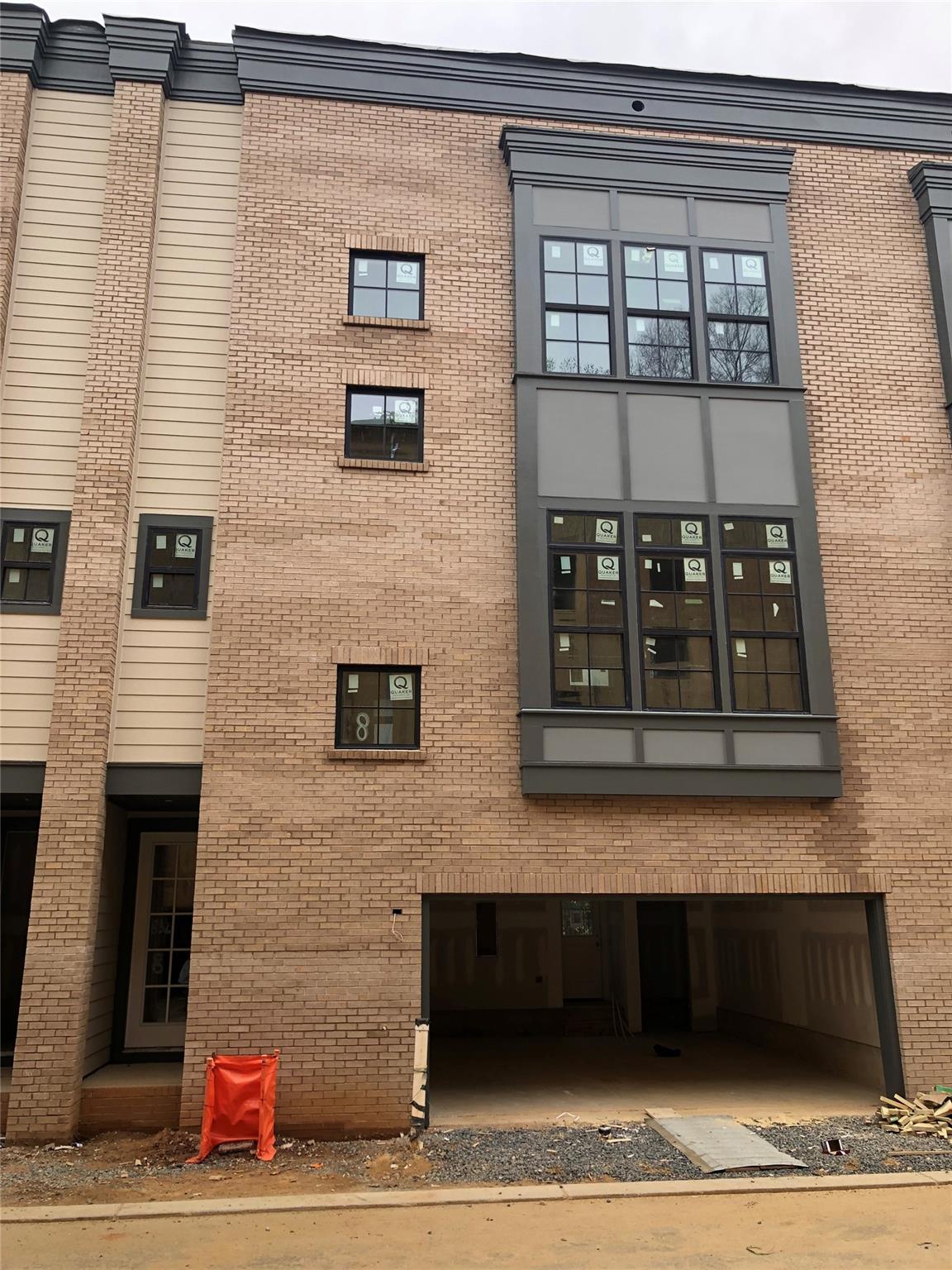 NEW Construction - brownstone style townhome in the heart of Madison Park! Lots of large windows and open spaces for a nice bright space. First level offers a 2 car side by side garage along with a bedroom suite that accesses a covered patio. Head up the hardwood stairs to the main level with spacious kitchen open to dining and family room. This level is set off by the statement staircase featuring steel railings. The third level features a spacious primary suite and another bedroom with it's own bath. Premium finishes include site finished hardwood floors, gas range with chimney hood, quartz countertops, shaker style soft close cabinets in the kitchen accented with champagne bronze hardware and fixtures. Primary suite features large walk in closet and luxurious primary bath with separate water closet, dual sink vanity, and upgraded tile shower. Stylish matte black and champagne bronze fixtures and lighting throughout. Small community of only 18 townhomes - hurry!