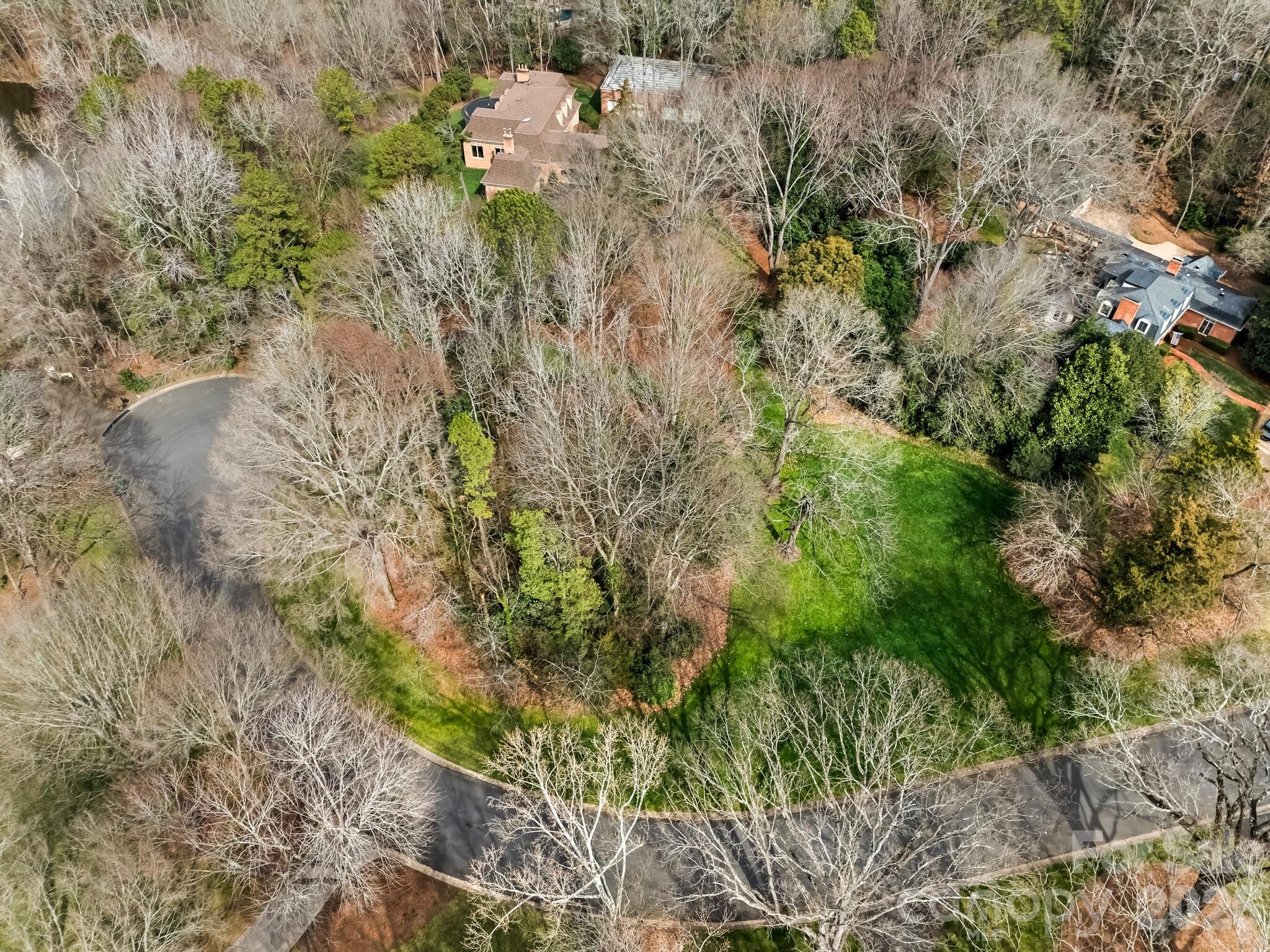 Hidden in one of the most charming small neighborhoods, this beautiful lot offers a rare opportunity to create something truly special. Surrounded by the warmth and character of an established well loved neighborhood, the property combines peaceful surroundings, quiet beauty and friendly neighbors. Enjoy the feeling of being tucked away while still remaining conveniently connected to nearby amenities. This is more than just a piece of land- it's a beautiful gift waiting to be opened.