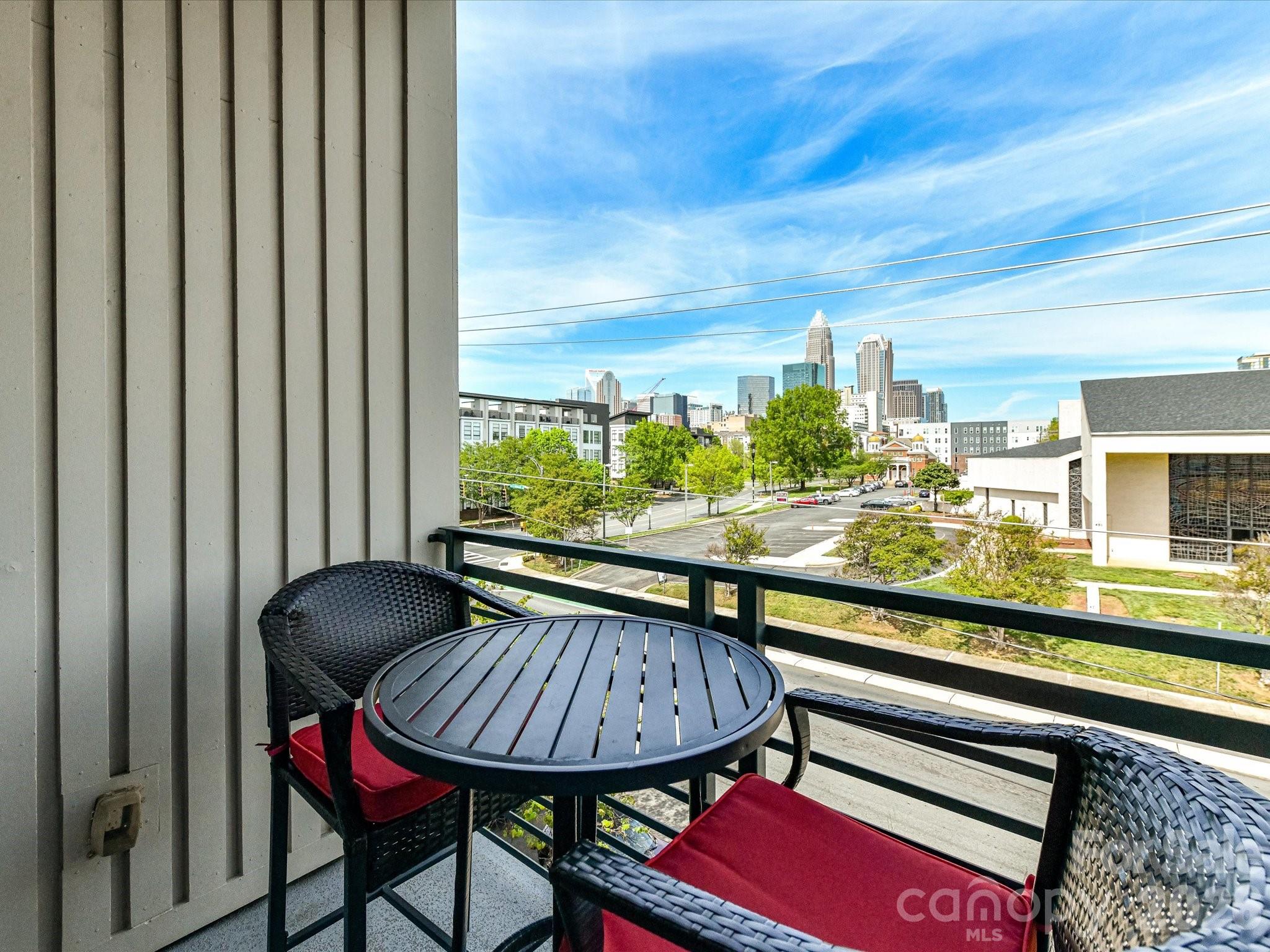 Experience Uptown living with stunning skyline views in the M Street Condominium community on N. McDowell Street. This stylish condo that could be sold fully furnished offers a flexible layout and low-maintenance living in a prime Charlotte location. The main entry level features a spacious bedroom, a full tiled bath and a den or office that works well for guests, remote work or added living space. Upstairs, the open floor plan is filled with natural light and designed for easy everyday living and entertaining. The kitchen features quartz countertops, tile backsplash, white cabinetry, stainless steel appliances and a center island with seating. It opens to the dining area and large living room, where windows frame beautiful skyline views. The third level is home to the private primary suite, complete with a well-appointed bath featuring a seamless glass shower, dual vanity and a stackable washer and dryer tucked into the bathroom closet for convenience. Step outside to your private balcony and take in amazing views of the Charlotte skyline. The basement level includes a one-car garage with direct access to the upper levels along with one additional assigned parking space.